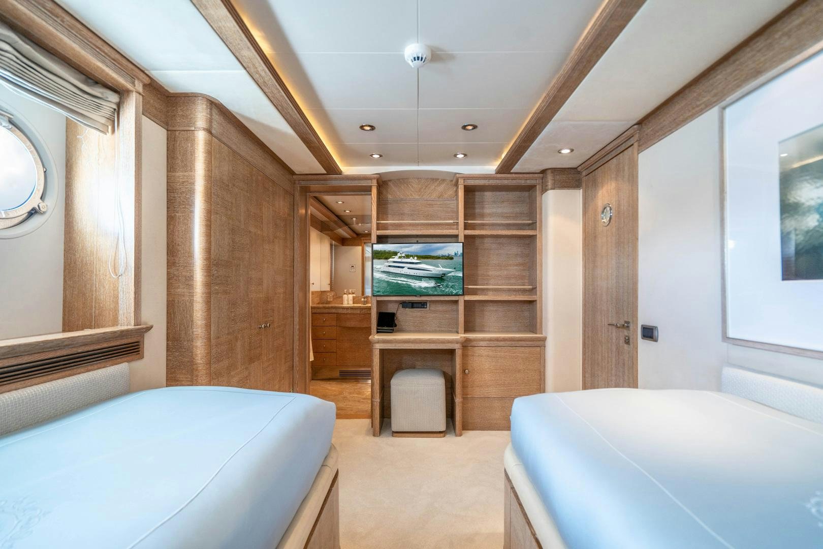 a room with a bed and a large wooden cabinet aboard ARTEMISEA Yacht for Sale