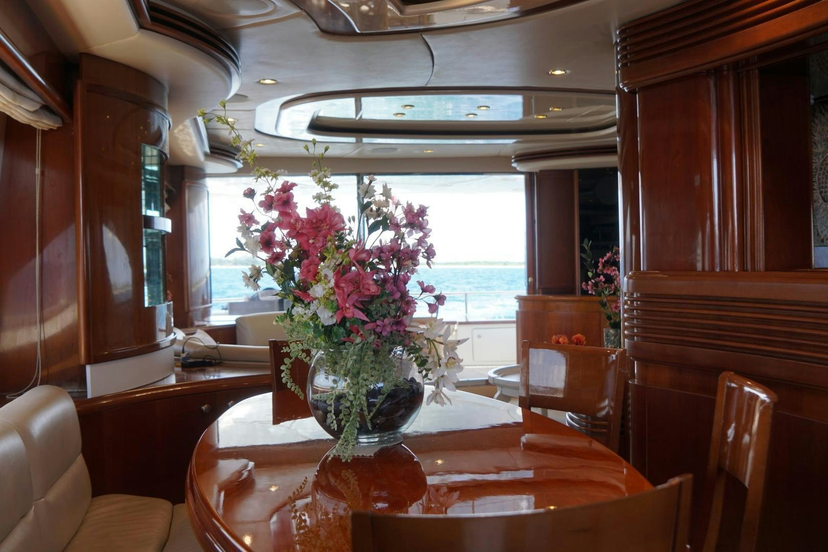 a vase of flowers on a table aboard AZURE Yacht for Sale