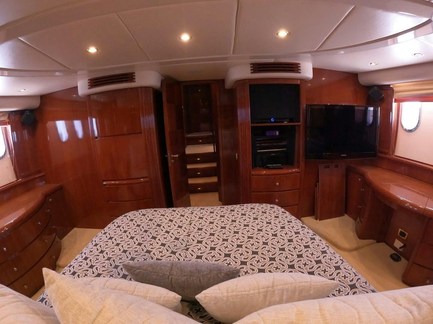 a bedroom with a bed and a tv aboard AZURE Yacht for Sale