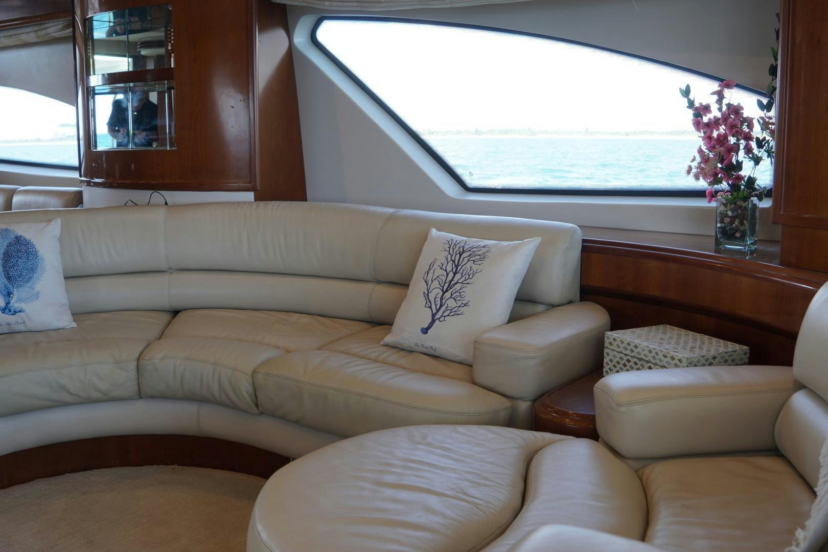 a couch with a vase of flowers on it aboard AZURE Yacht for Sale