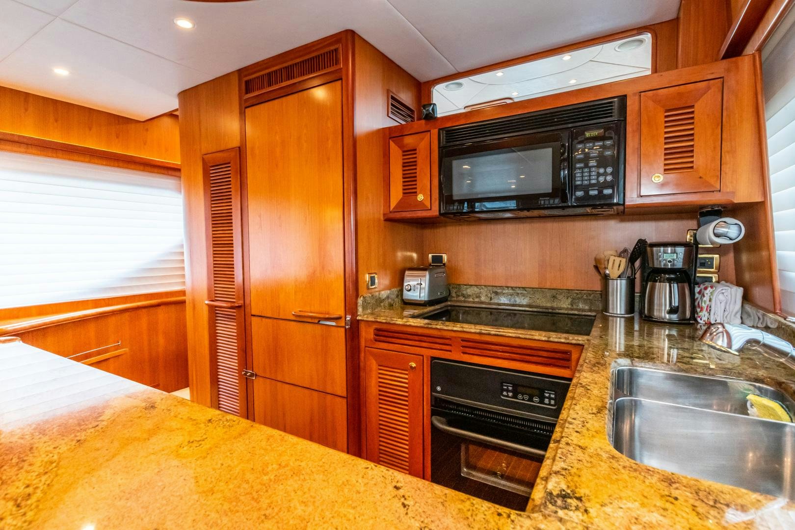 a kitchen with wooden cabinets aboard TJ SQUARED Yacht for Sale