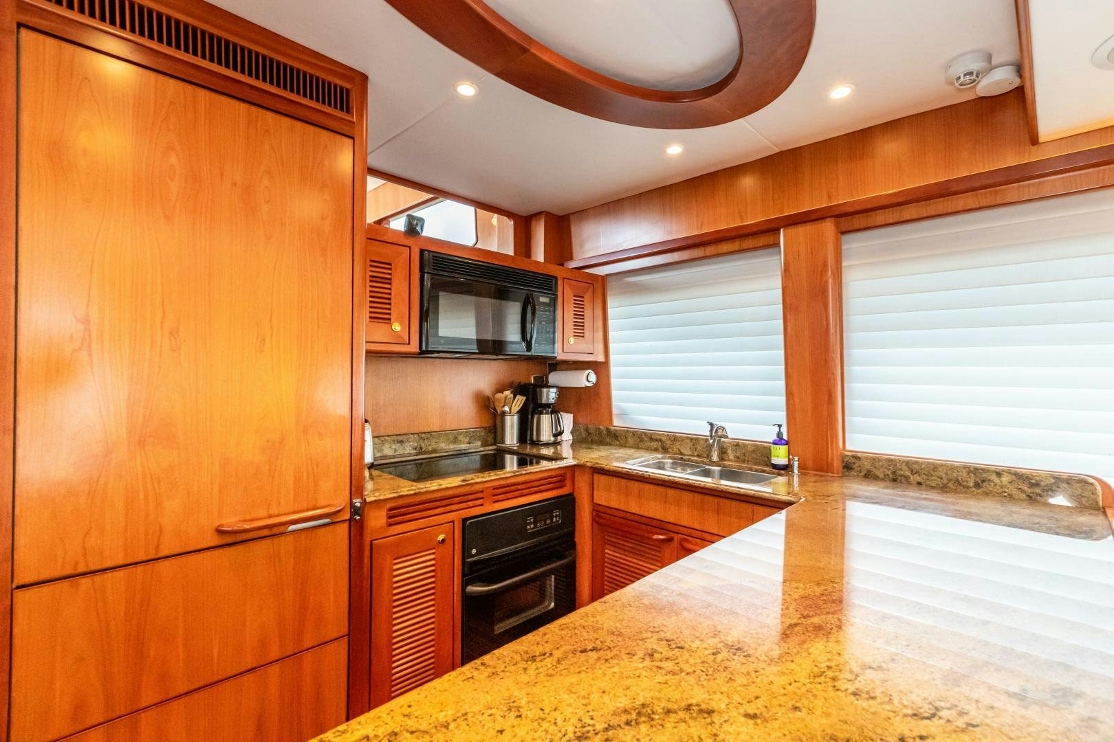 a kitchen with wooden cabinets aboard TJ SQUARED Yacht for Sale