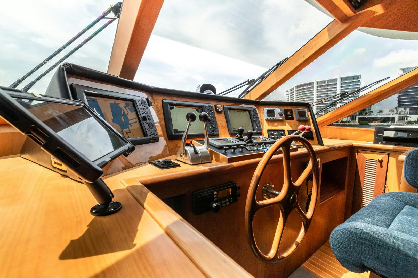 a wooden desk with electronic devices aboard TJ SQUARED Yacht for Sale