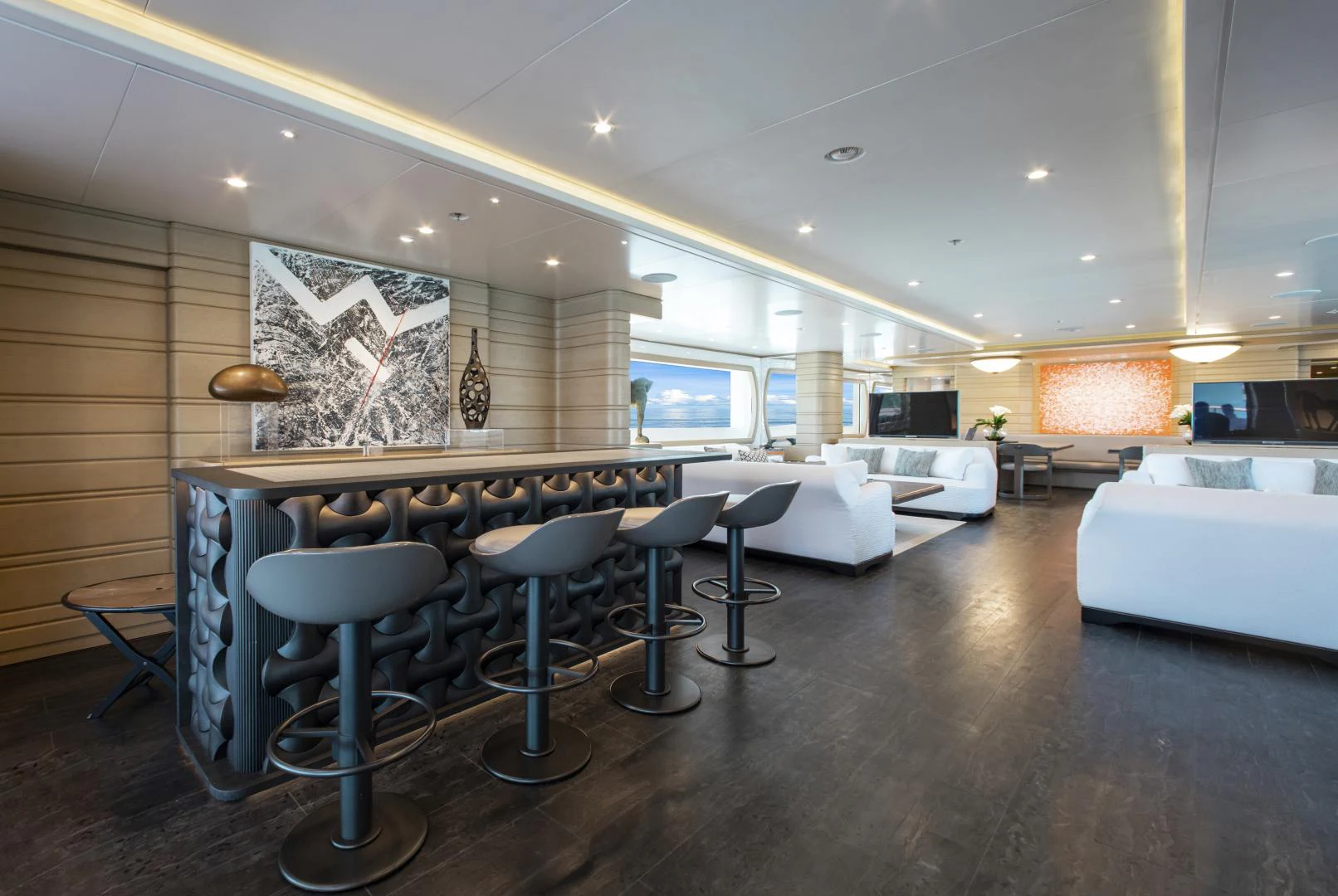a large room with a large table and chairs aboard MOCA Yacht for Charter