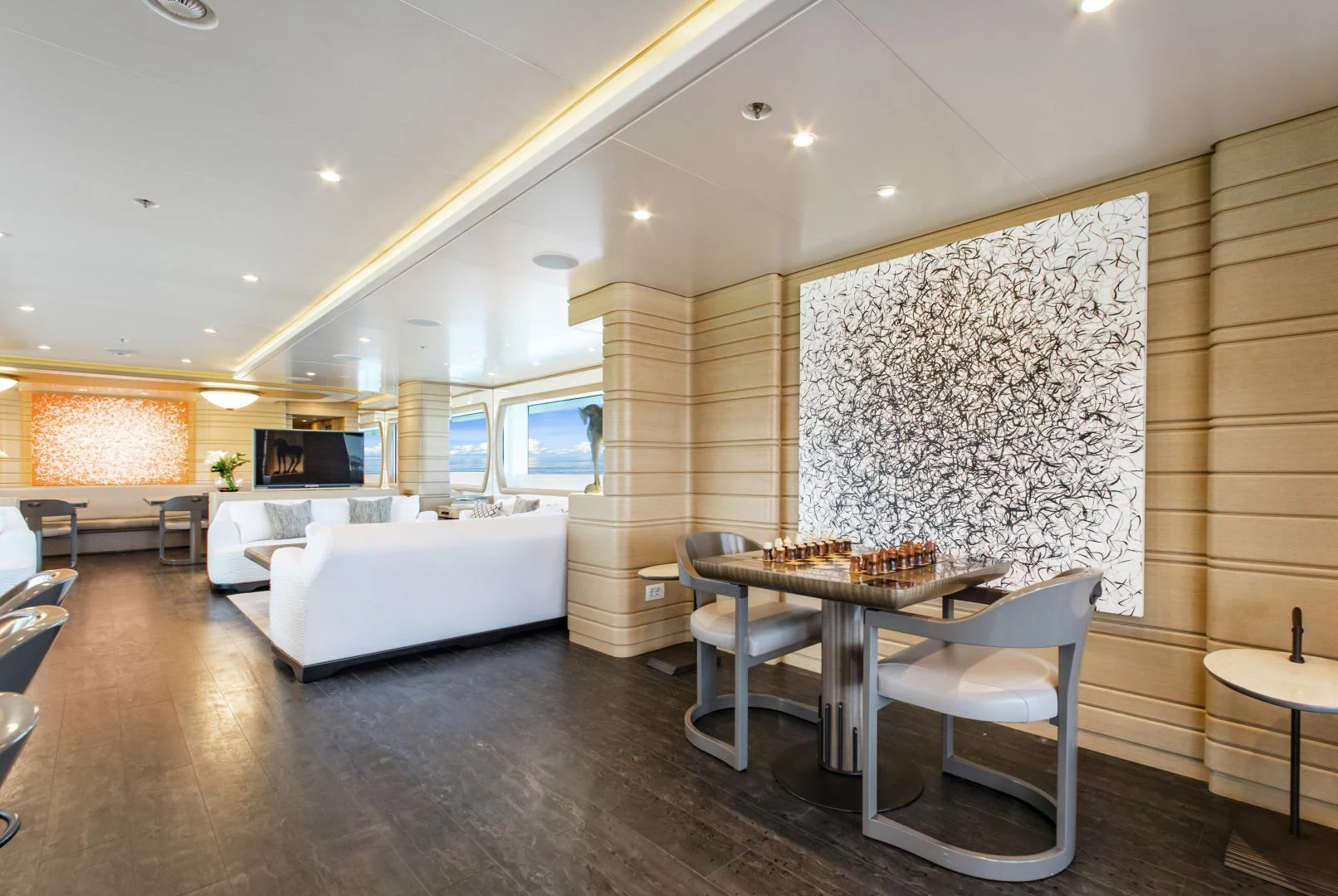a room with a table and chairs aboard MOCA Yacht for Charter
