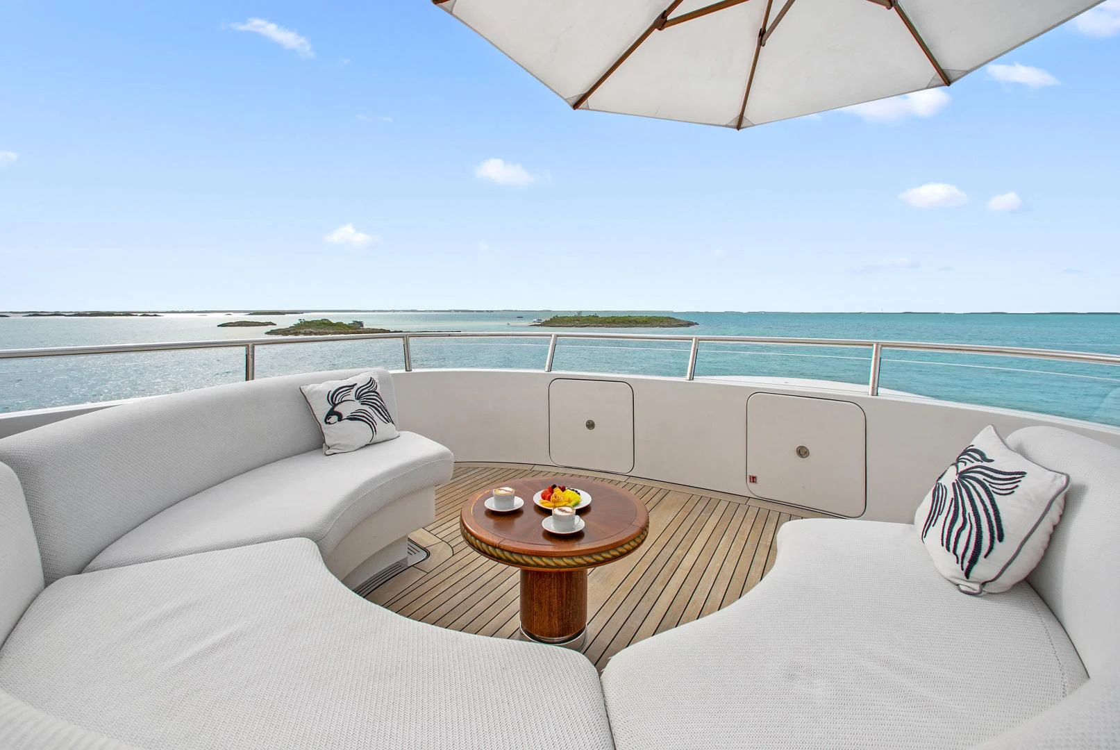 a room with a couch and a table and a pool aboard MOCA Yacht for Charter