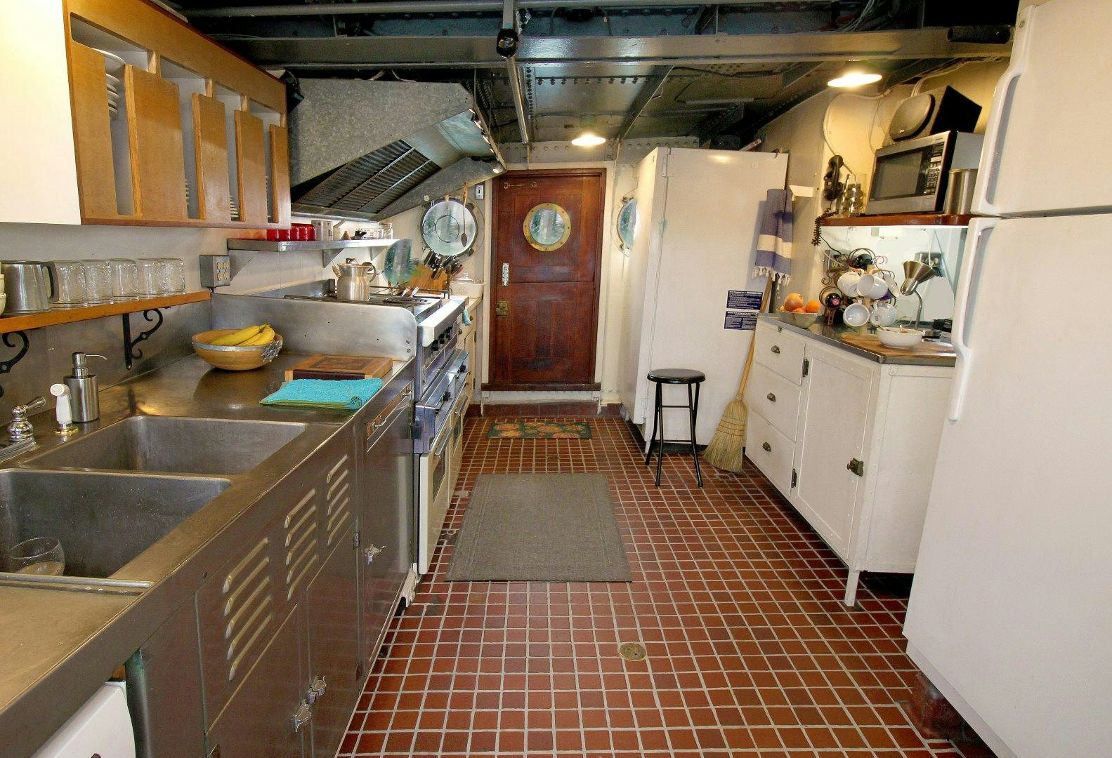 a kitchen with a red tile floor aboard SACAJAWEA Yacht for Sale