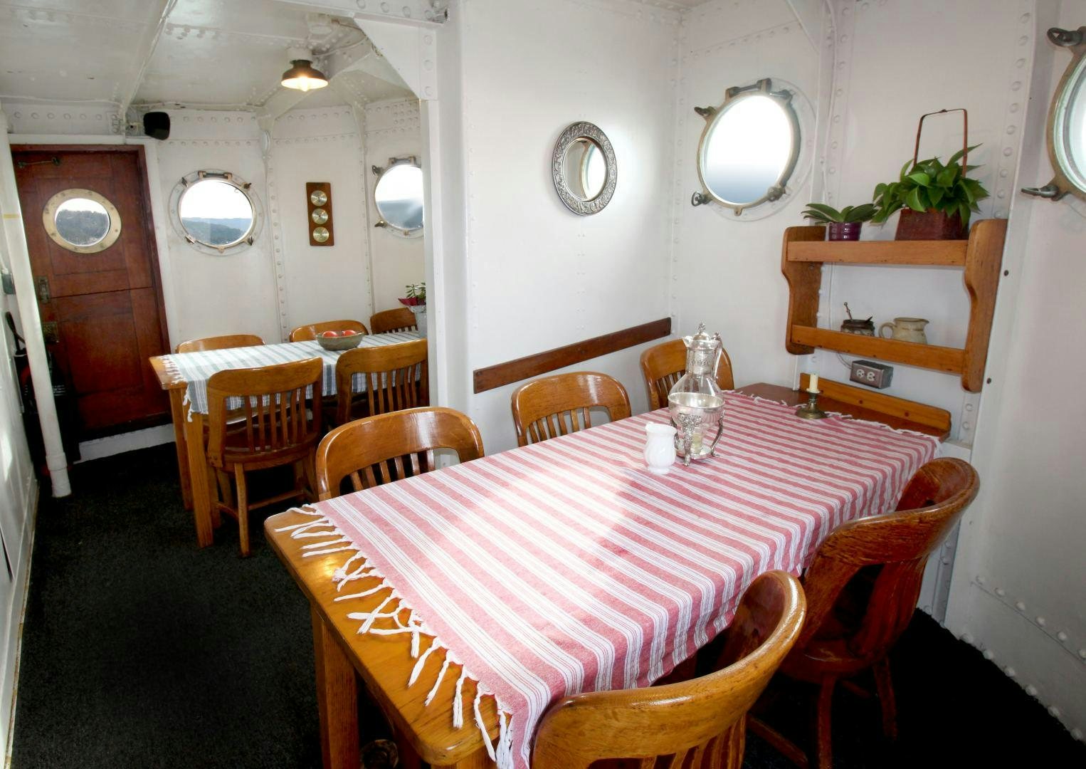 a dining room with tables and chairs aboard SACAJAWEA Yacht for Sale