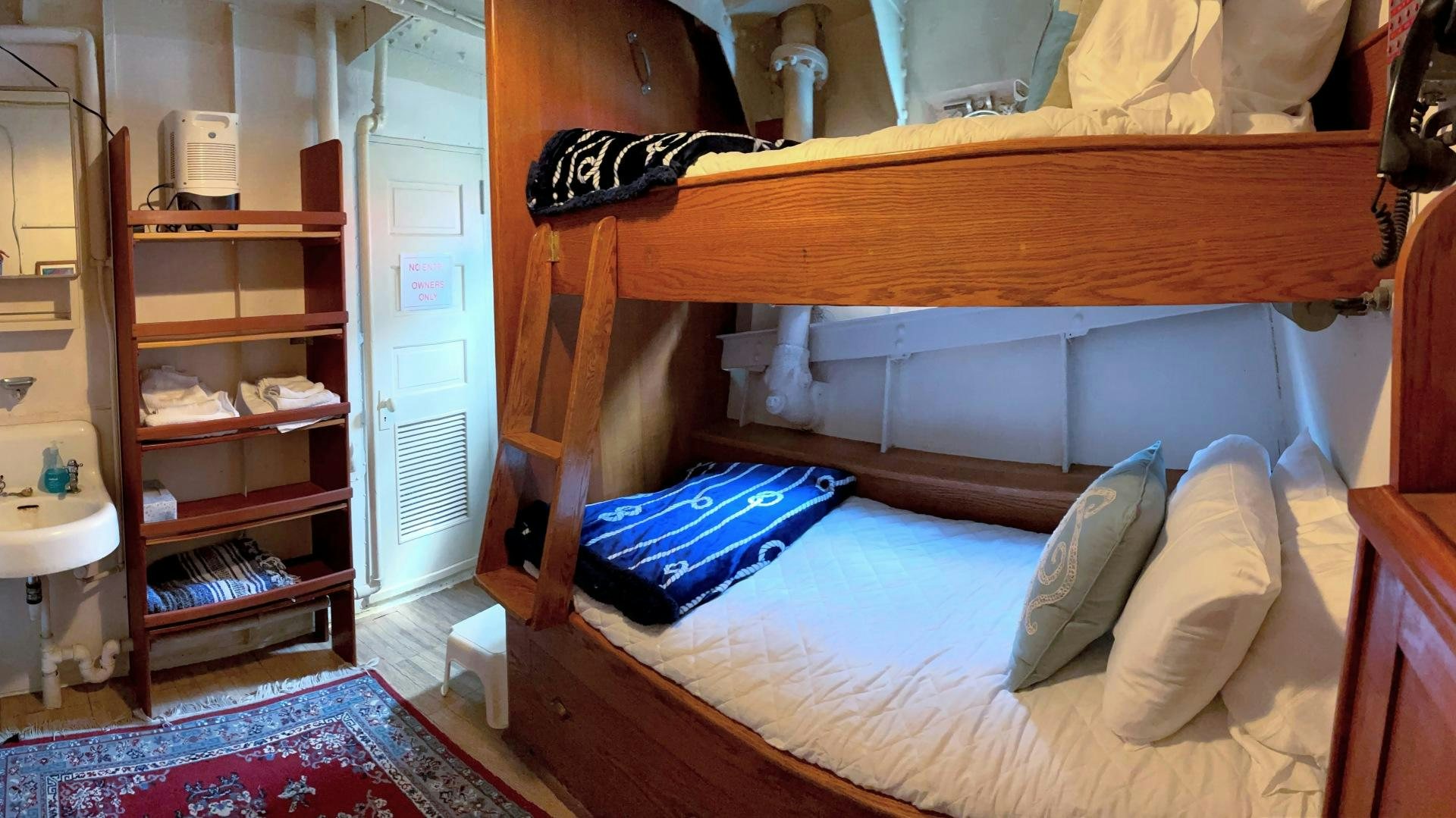 a bed with a blue pillow aboard SACAJAWEA Yacht for Sale