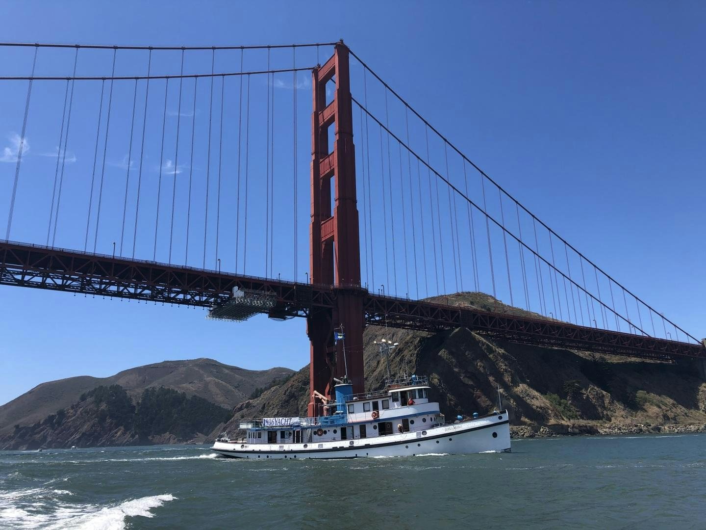 a boat under a bridge aboard SACAJAWEA Yacht for Sale