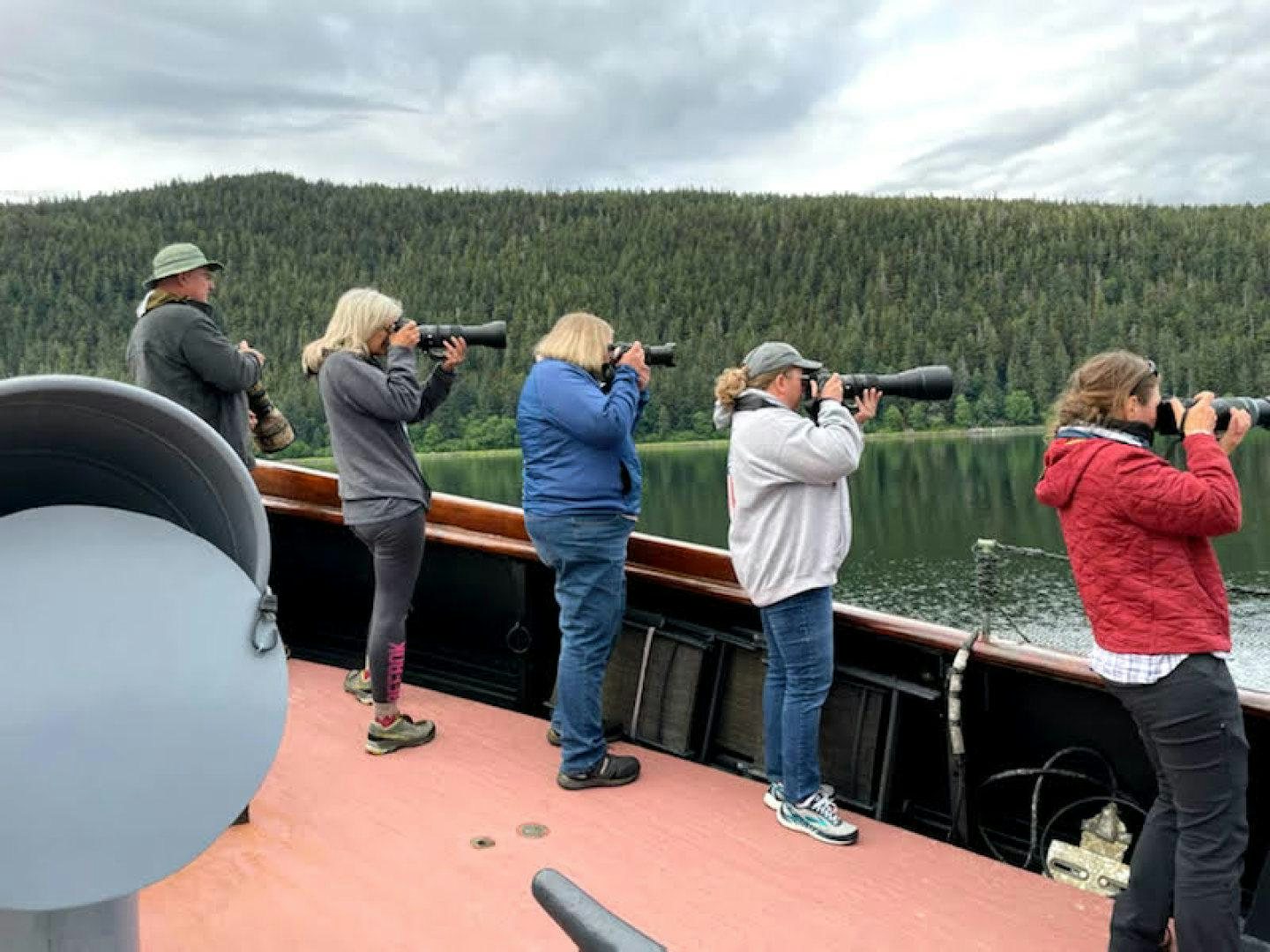 a group of people taking pictures of a mountain aboard SACAJAWEA Yacht for Sale