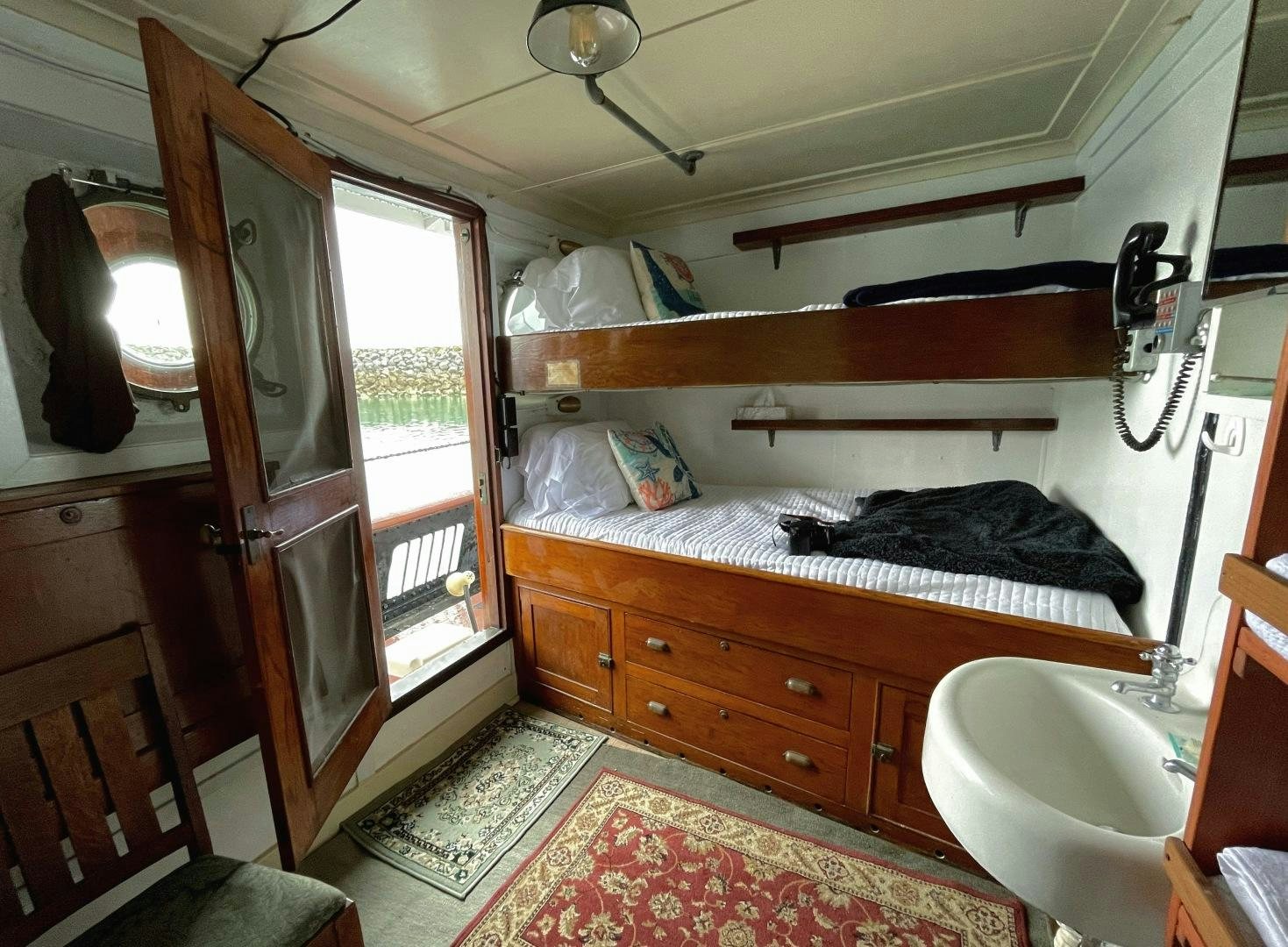 a small bedroom with a bed aboard SACAJAWEA Yacht for Sale
