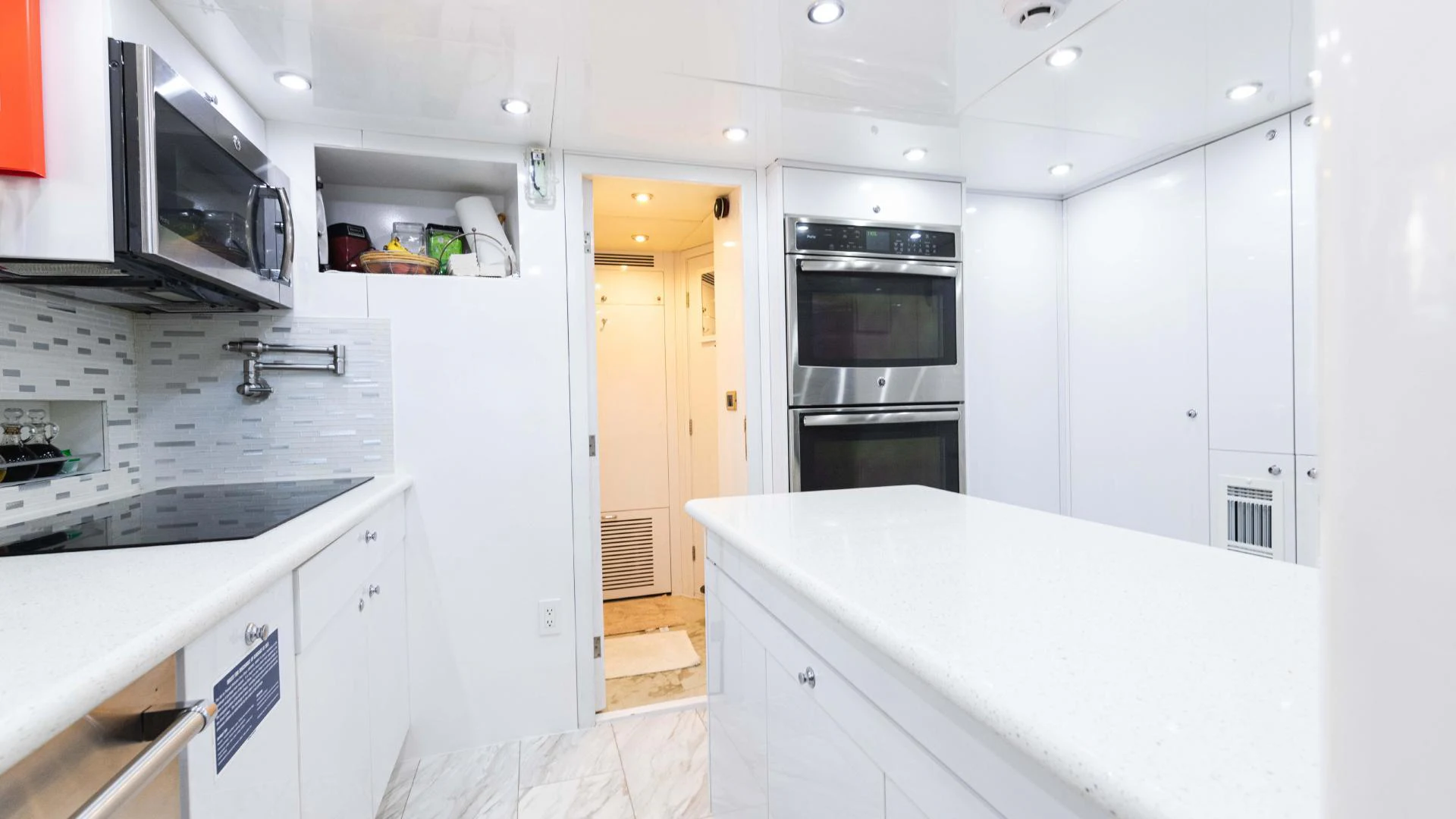 a kitchen with white cabinets aboard ARTHUR’S WAY Yacht for Sale