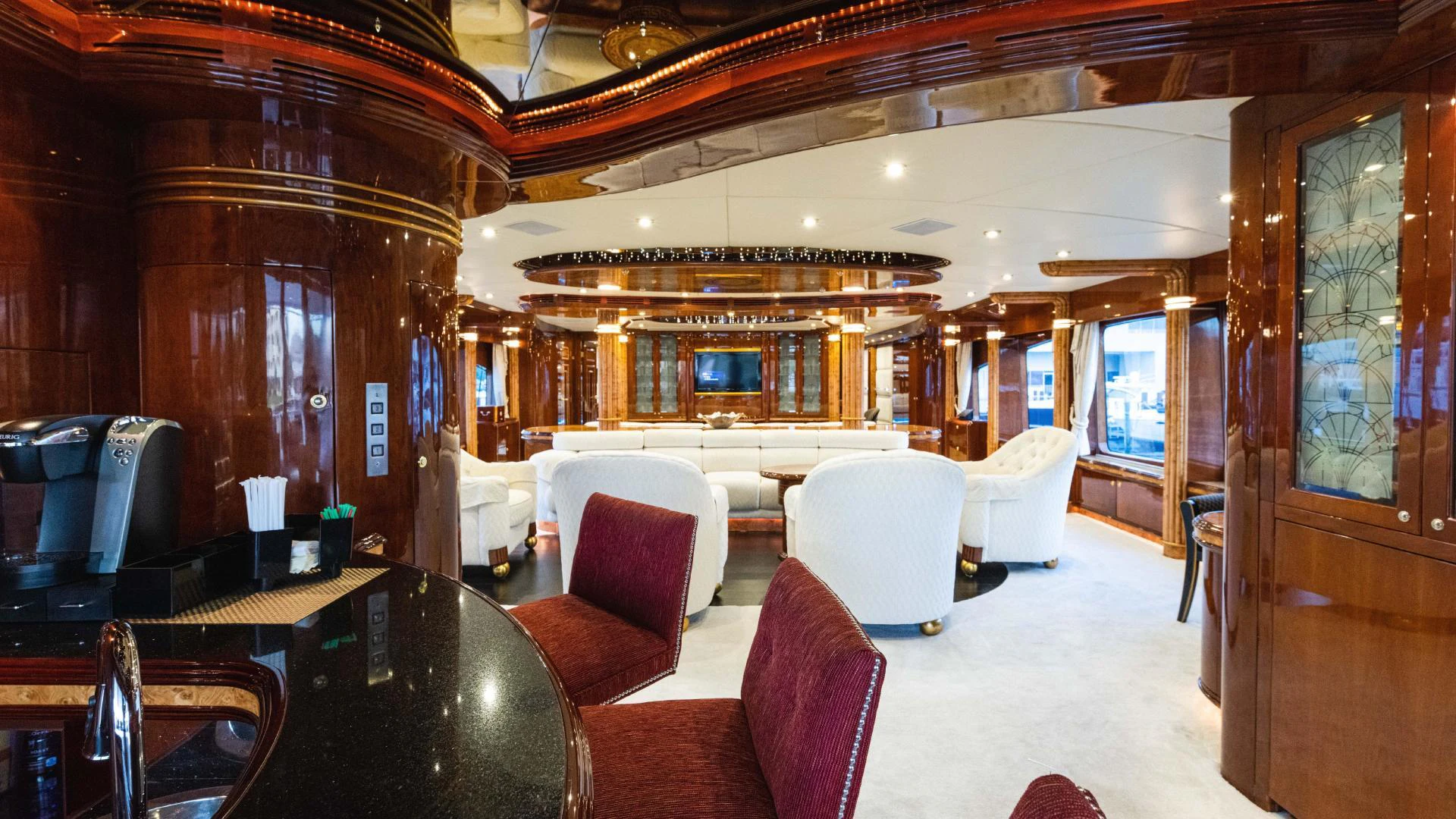 a room with a table chairs and a tv aboard ARTHUR’S WAY Yacht for Sale