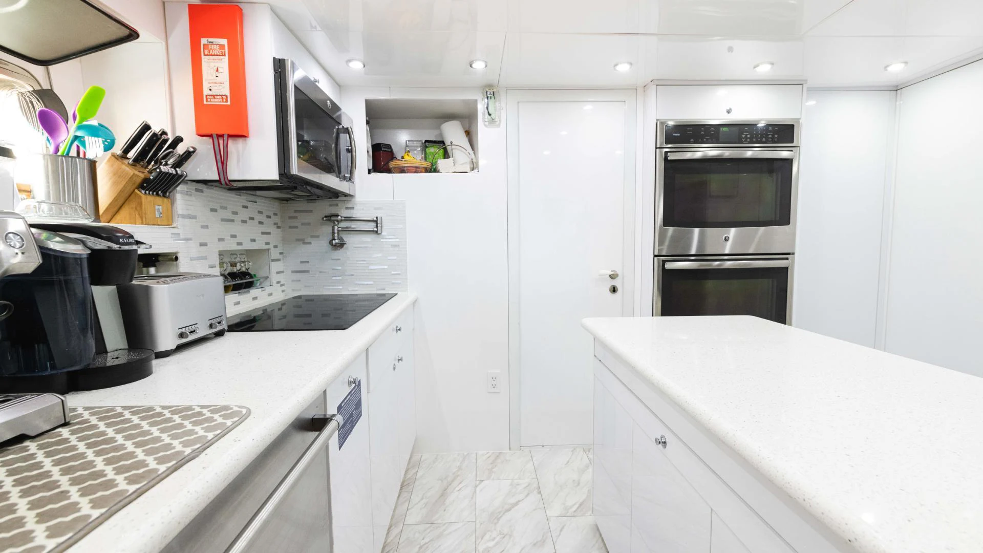 a kitchen with white cabinets aboard ARTHUR’S WAY Yacht for Sale
