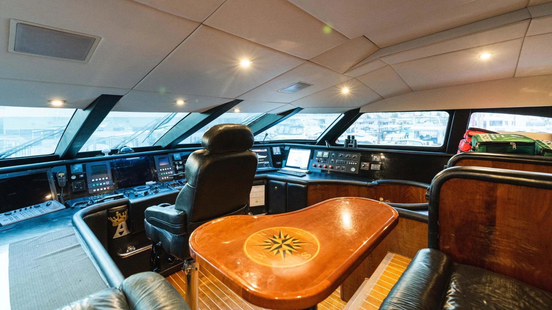 inside of a car with seats and a table with chairs and a laptop on it aboard ARTHUR’S WAY Yacht for Sale