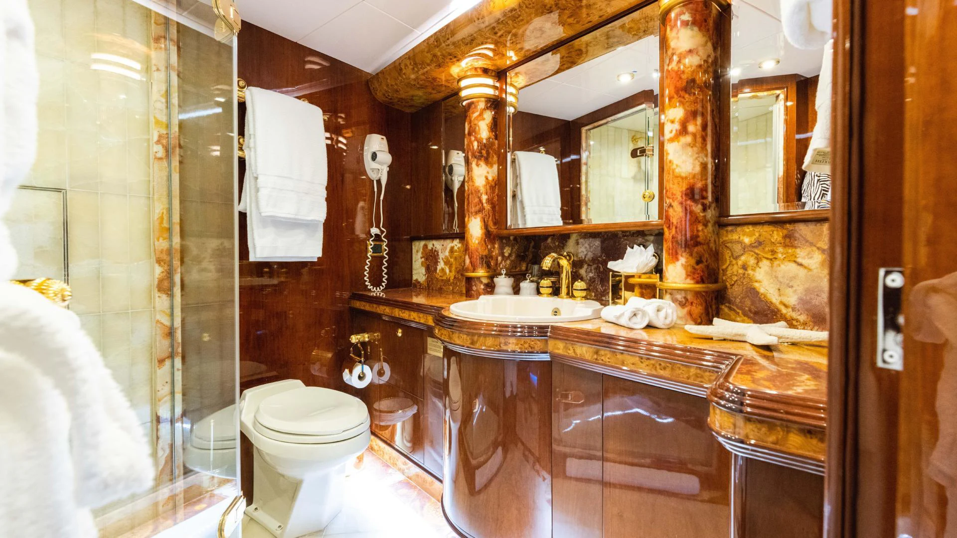 a bathroom with a large mirror aboard ARTHUR’S WAY Yacht for Sale