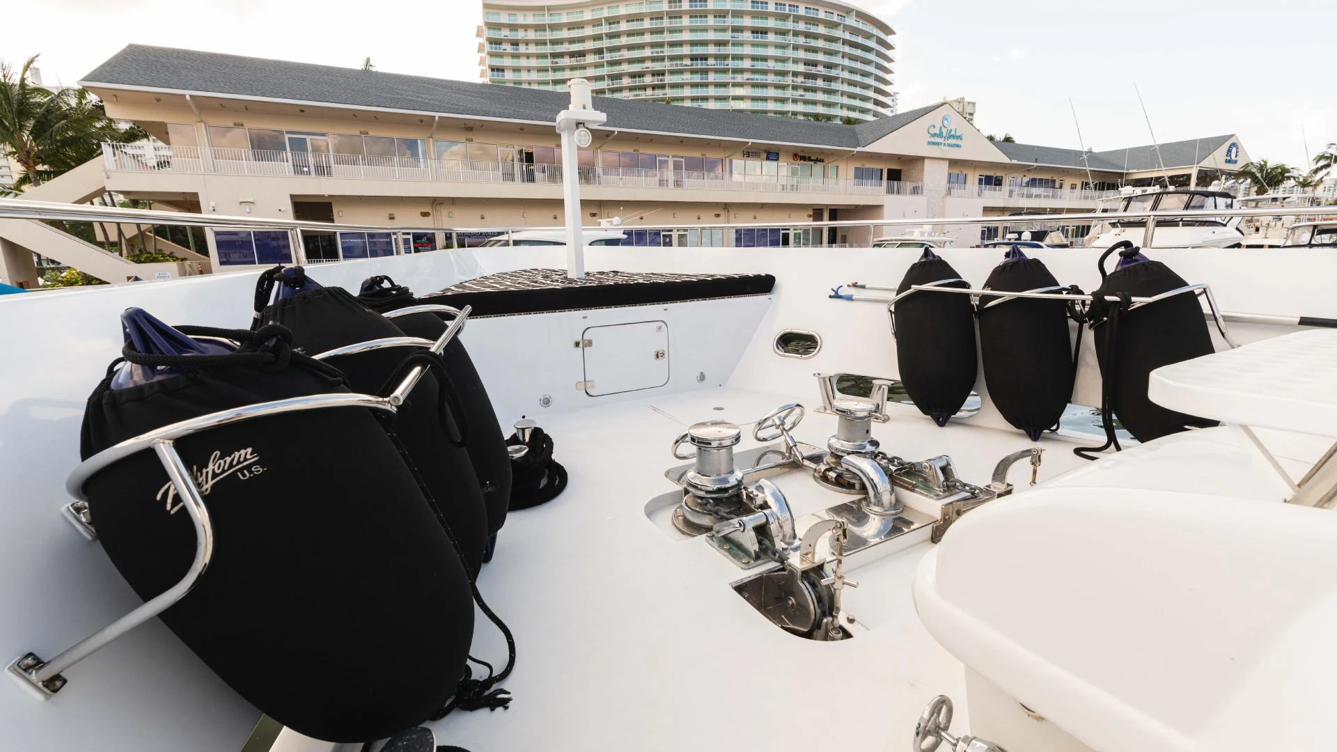a pair of black sunglasses on a white surface with a building in the background aboard ARTHUR’S WAY Yacht for Sale