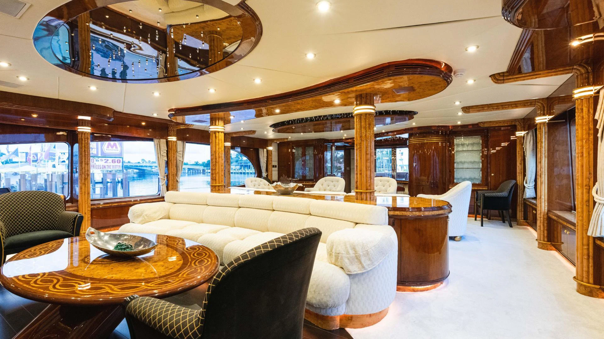 a large living room with a large wood table and chairs aboard ARTHUR’S WAY Yacht for Sale