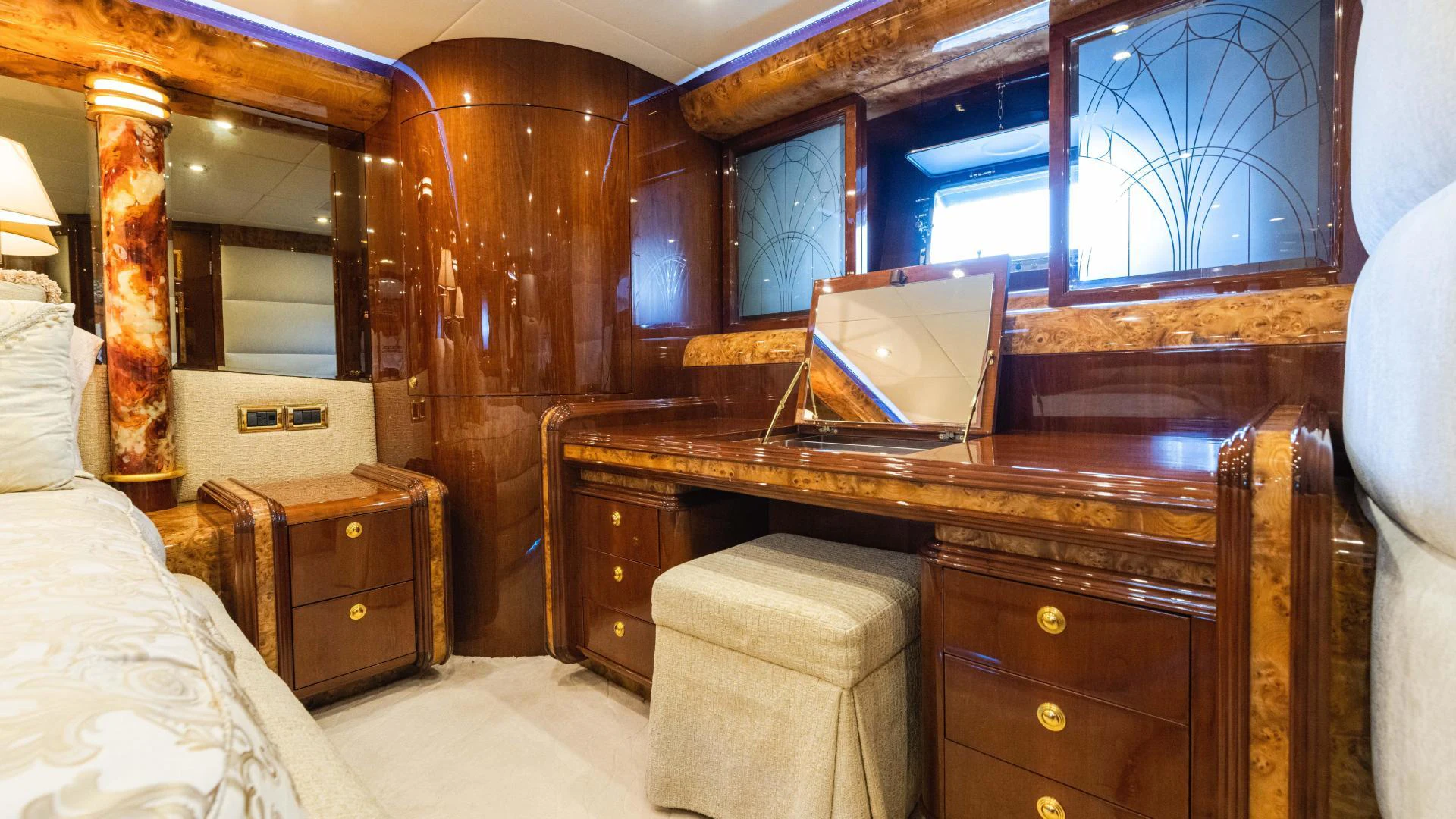 a bedroom with a laptop on a dresser aboard ARTHUR’S WAY Yacht for Sale