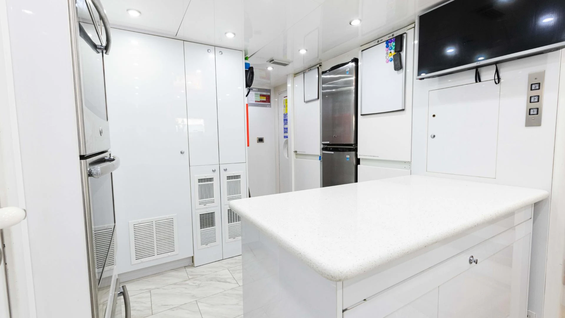a kitchen with white cabinets aboard ARTHUR’S WAY Yacht for Sale