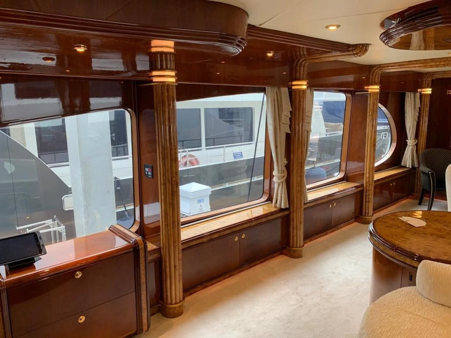 a room with a wood wall and a wood table and a window aboard ARTHUR’S WAY Yacht for Sale