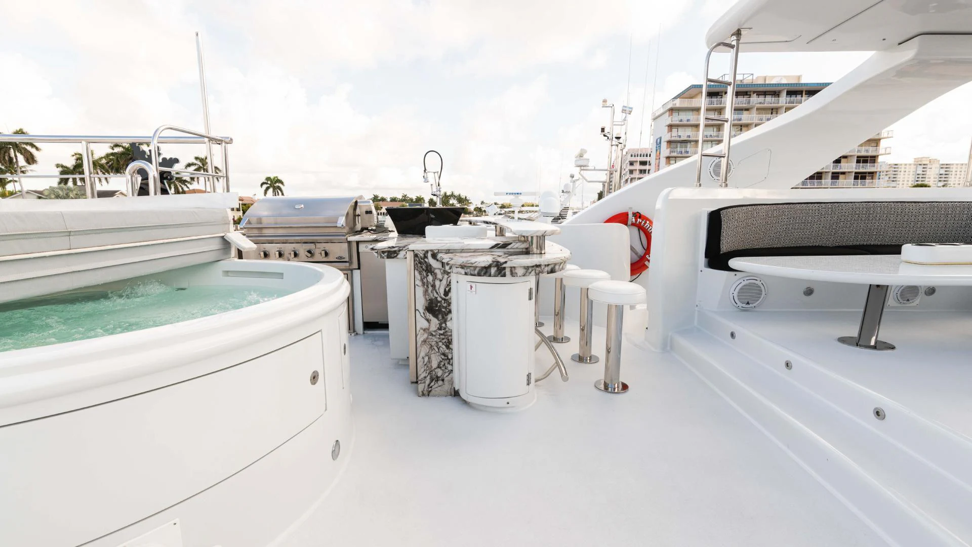 a white boat with a red ribbon on the front aboard ARTHUR’S WAY Yacht for Sale