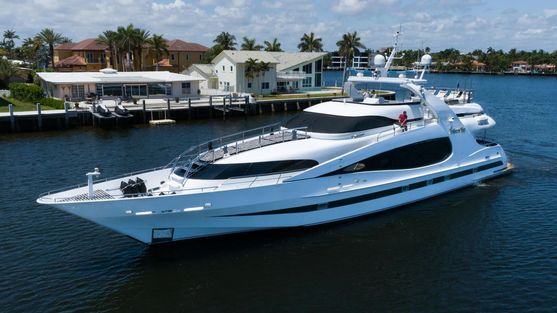 a white yacht in a harbor aboard ARTHUR’S WAY Yacht for Sale