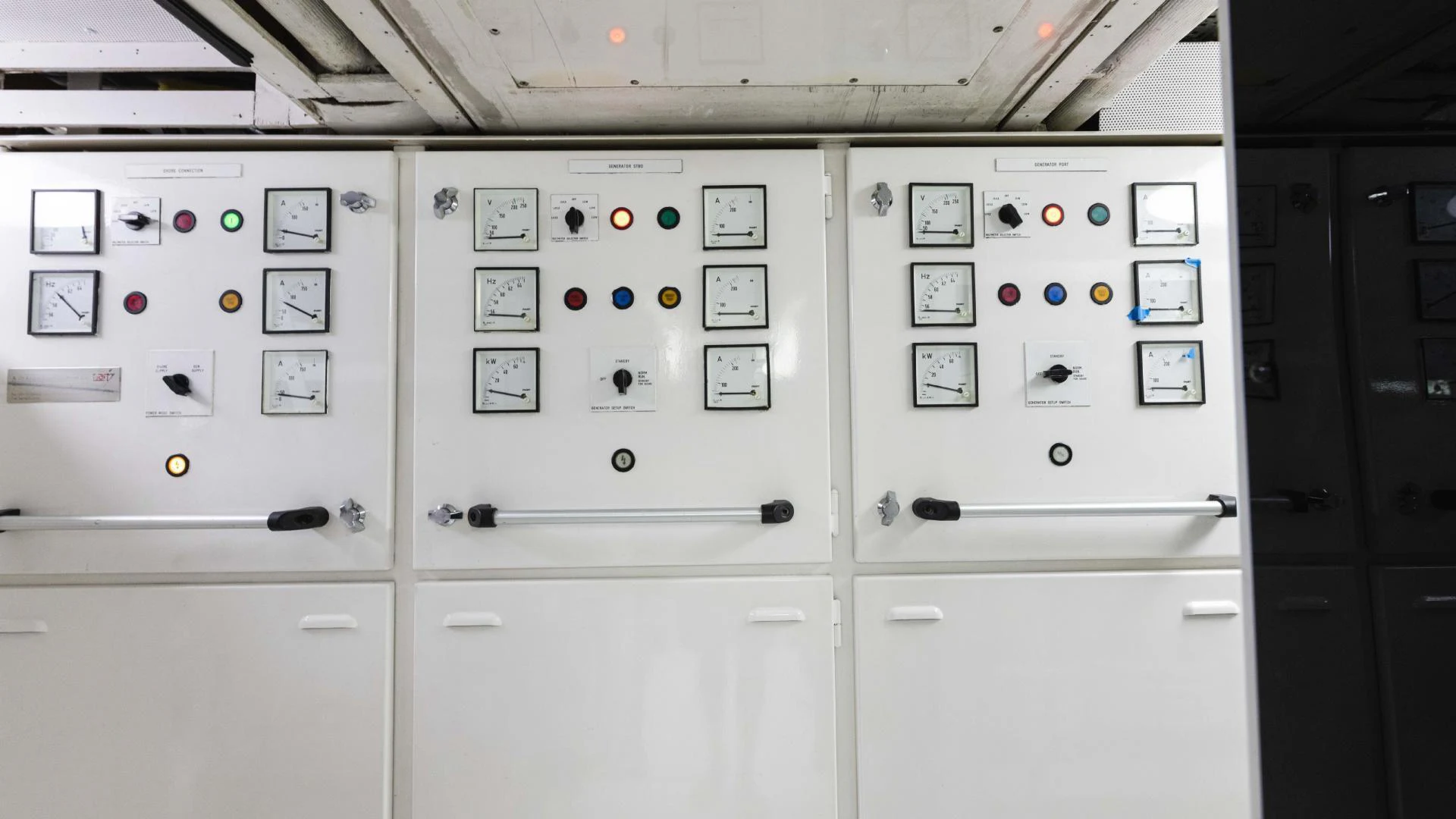 a white panel with black and red buttons and switches aboard ARTHUR’S WAY Yacht for Sale