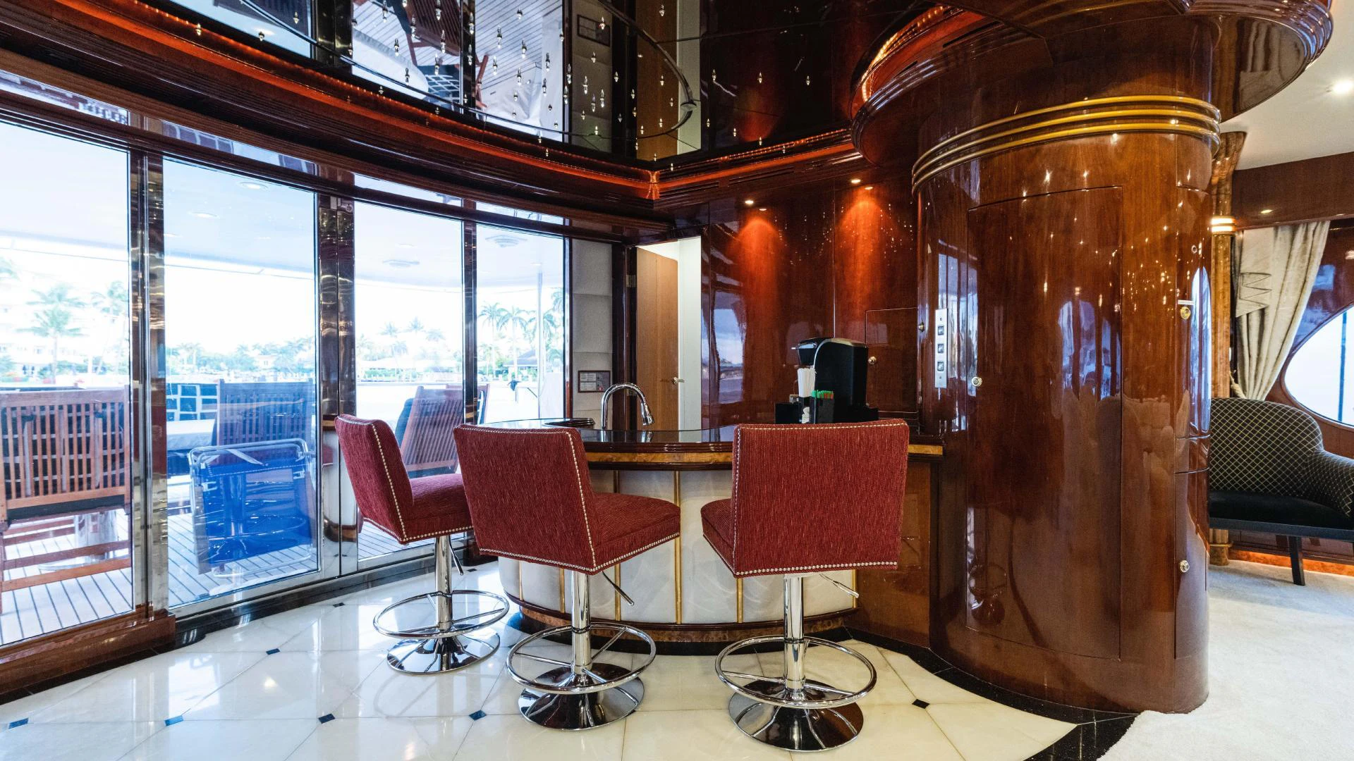 a large wooden barrel next to a red chair and a red chair aboard ARTHUR’S WAY Yacht for Sale