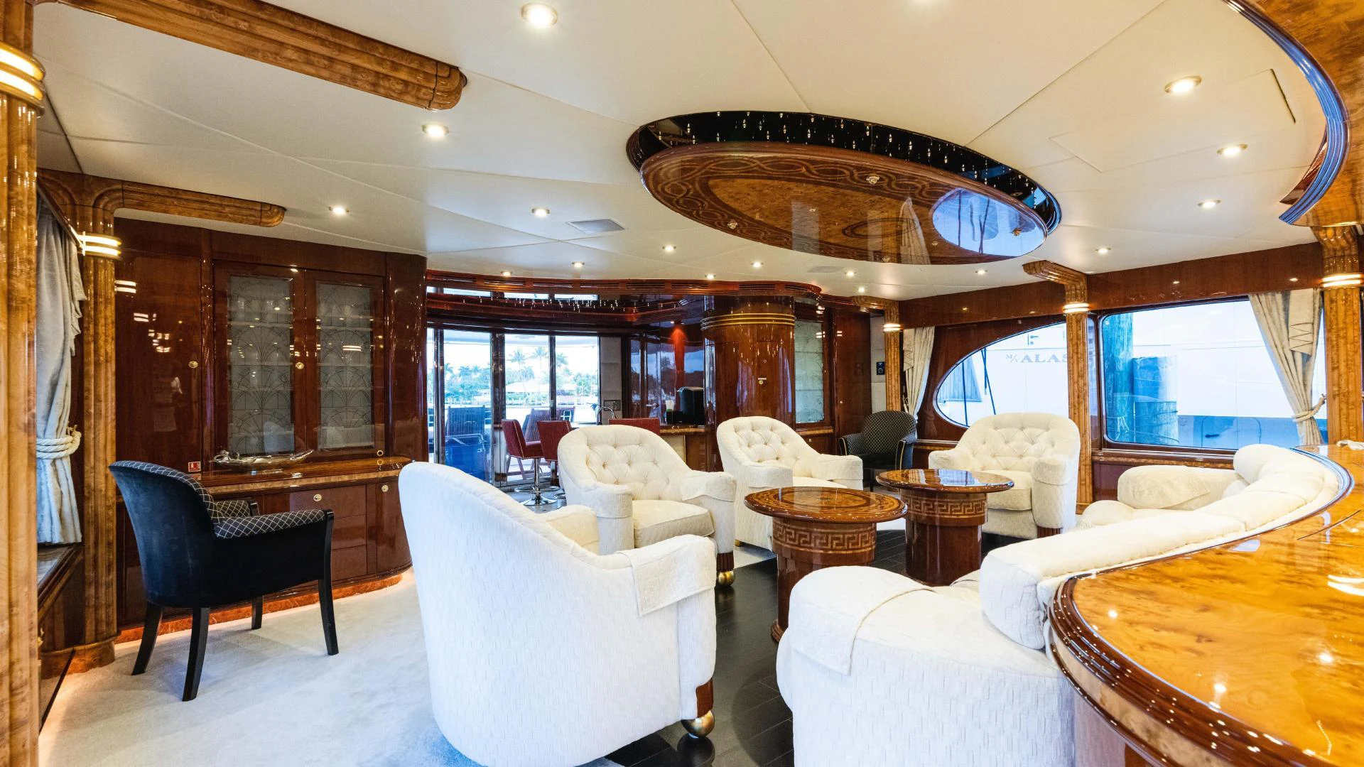 a room with a chandelier and chairs aboard ARTHUR’S WAY Yacht for Sale
