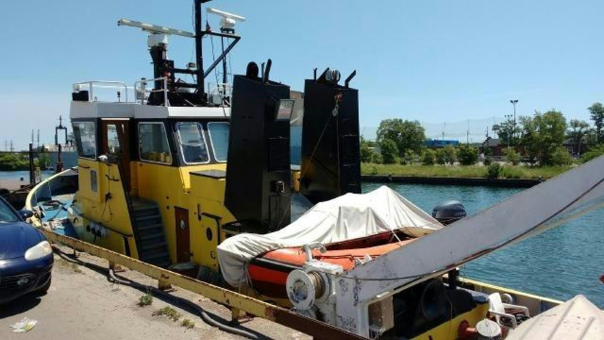 a large yellow machine on a dock aboard ITINERANTE I Yacht for Sale