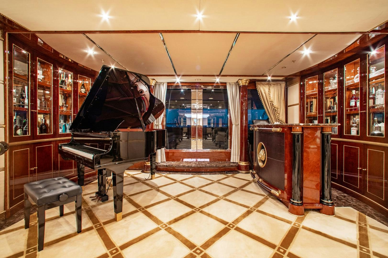a room with a piano and a stand up piano aboard SORRENTO Yacht for Sale