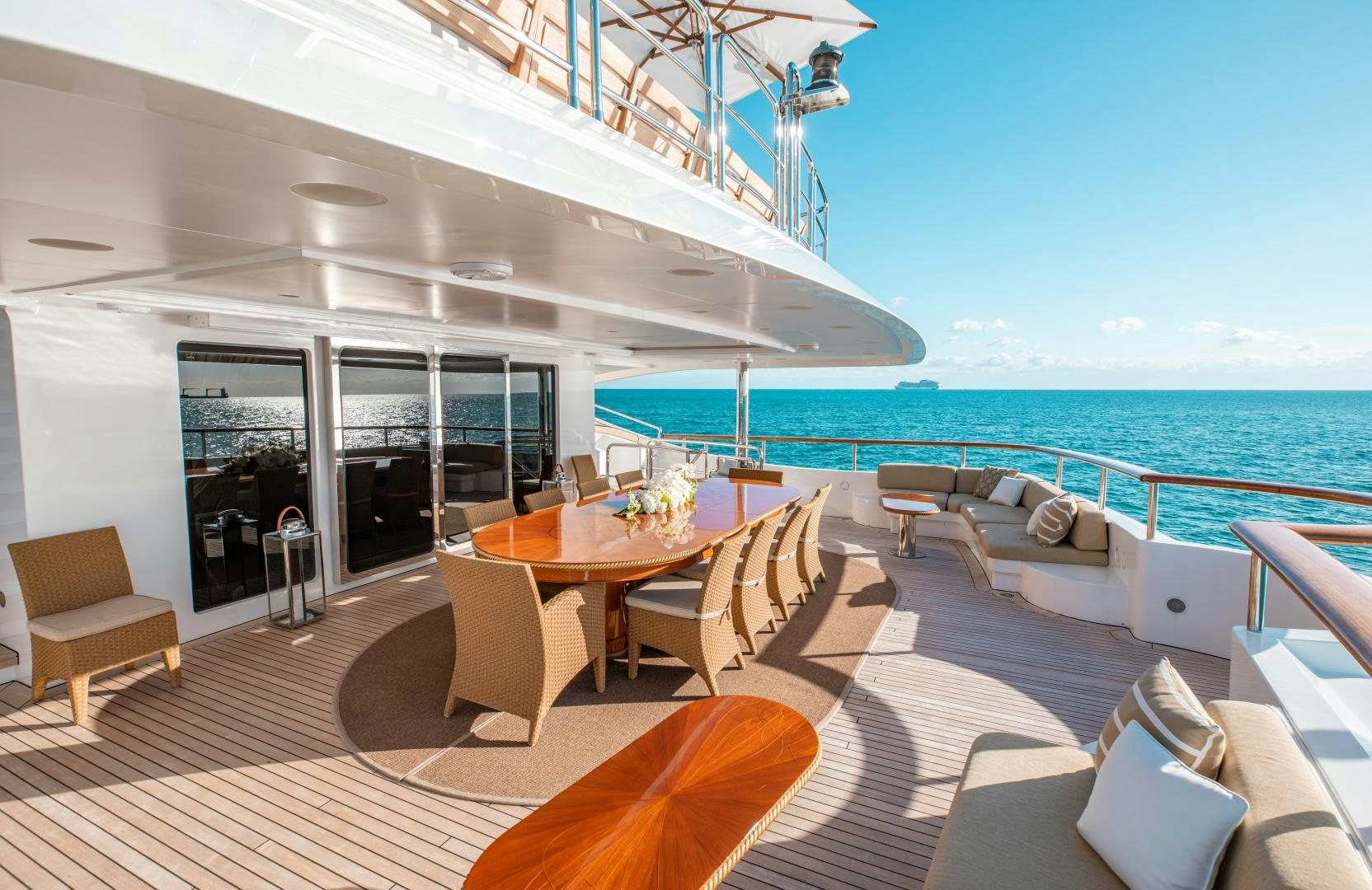 a deck with a table and chairs on it aboard SORRENTO Yacht for Sale