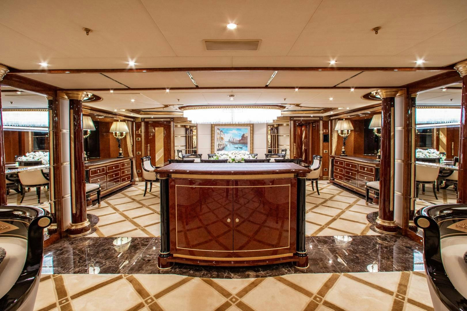 a large room with a bar and a table aboard SORRENTO Yacht for Sale