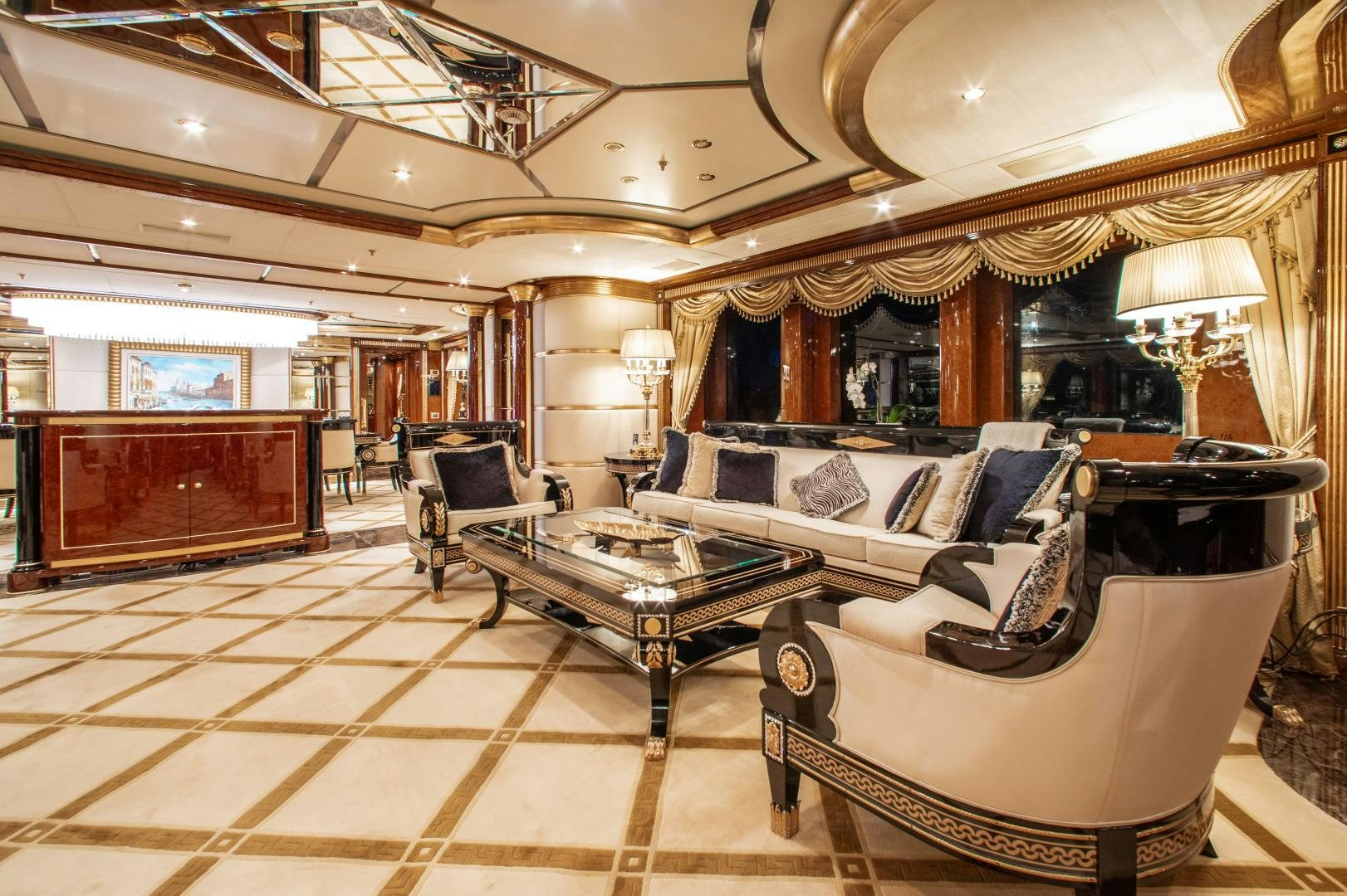 a large living room with a large chandelier aboard SORRENTO Yacht for Sale