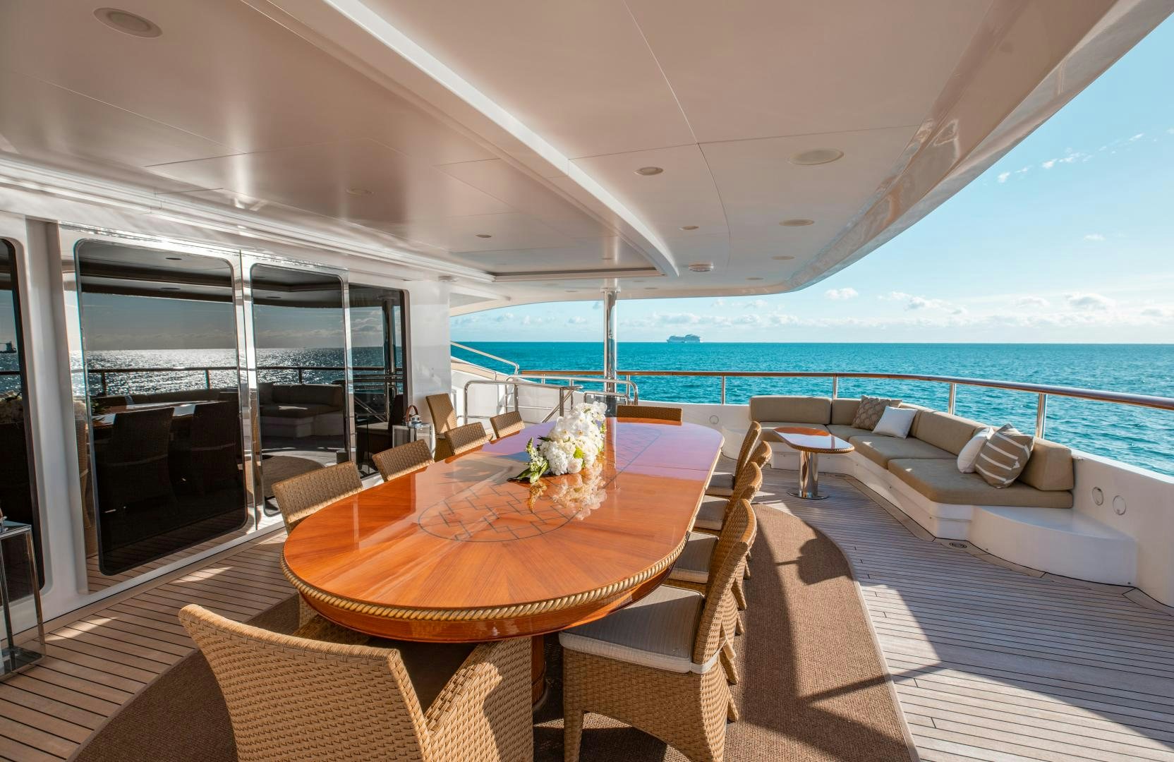 a table and chairs on a deck overlooking a large body of water aboard SORRENTO Yacht for Sale