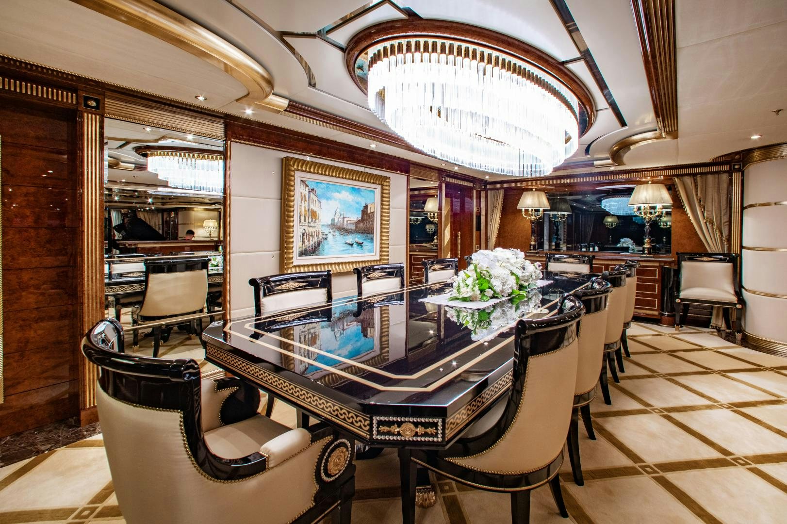a large room with a table and chairs aboard SORRENTO Yacht for Sale