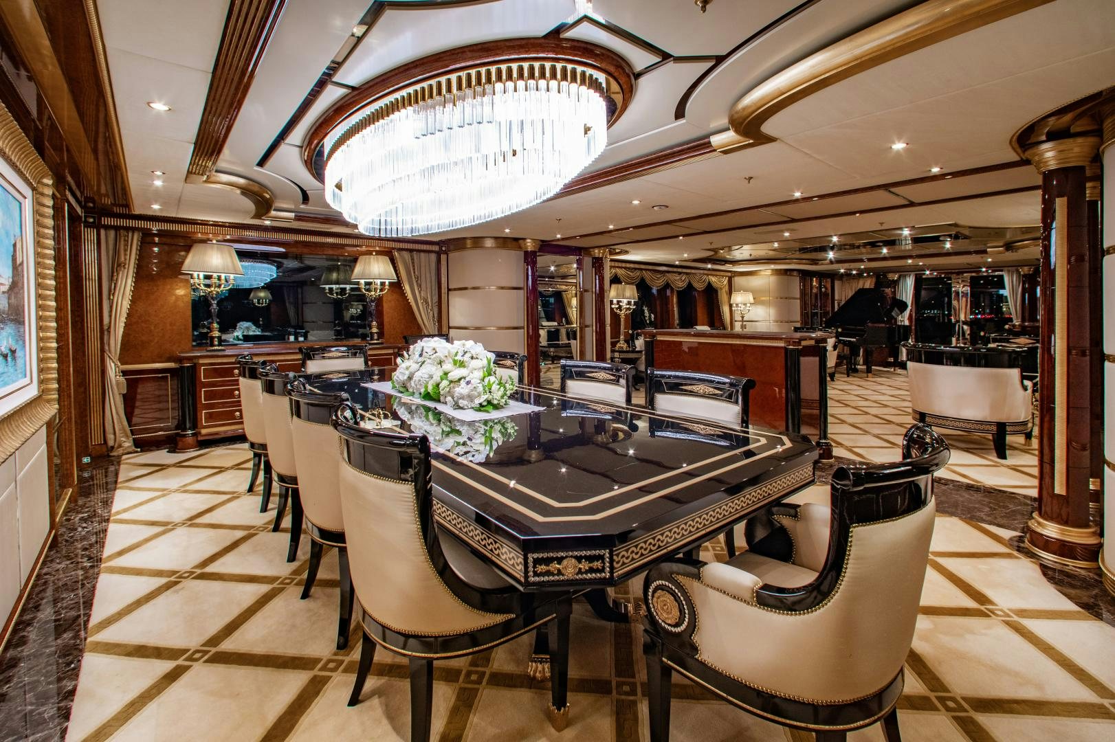 a large room with a table and chairs aboard SORRENTO Yacht for Sale