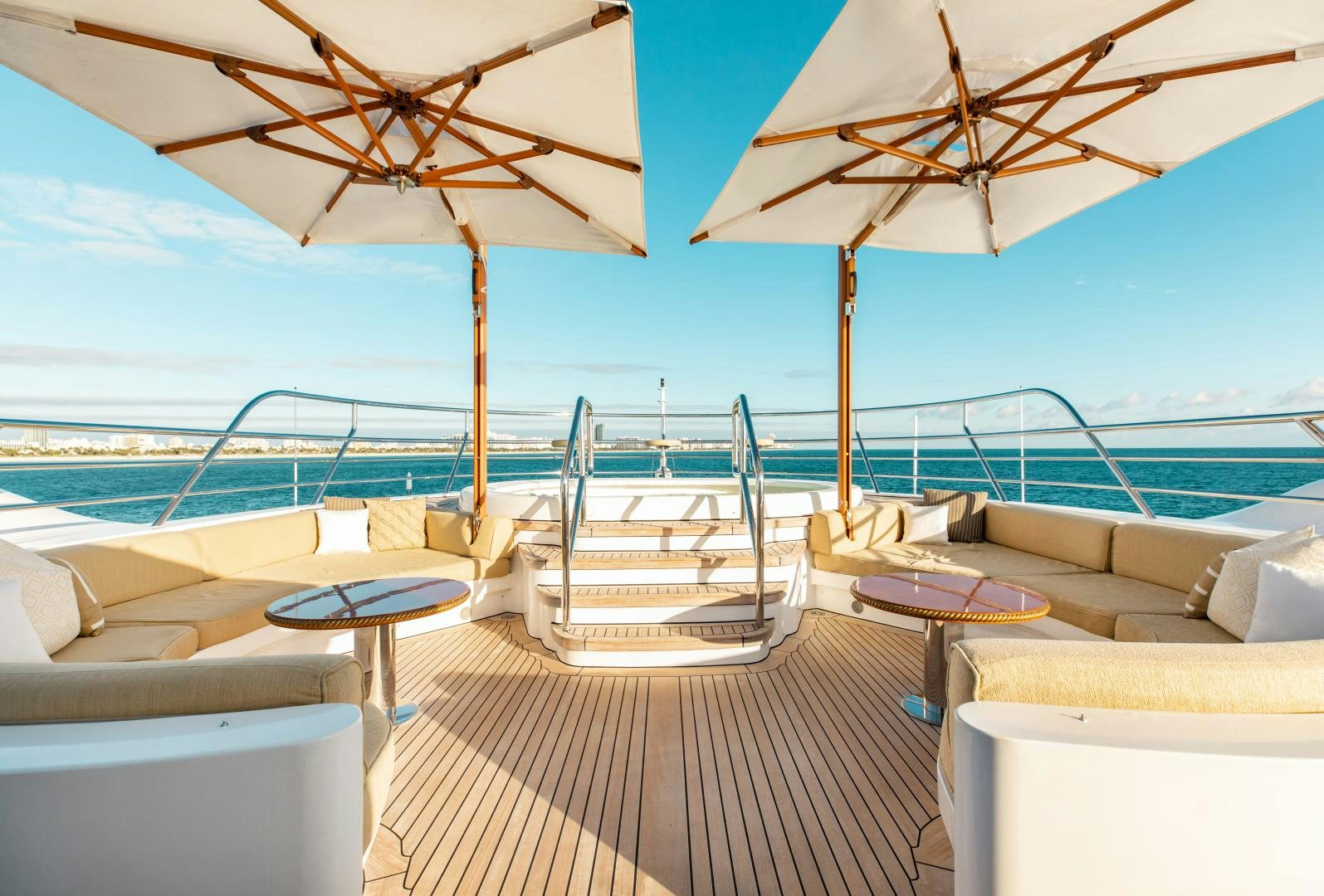 a lounge area with a lounge chair and umbrellas aboard SORRENTO Yacht for Sale