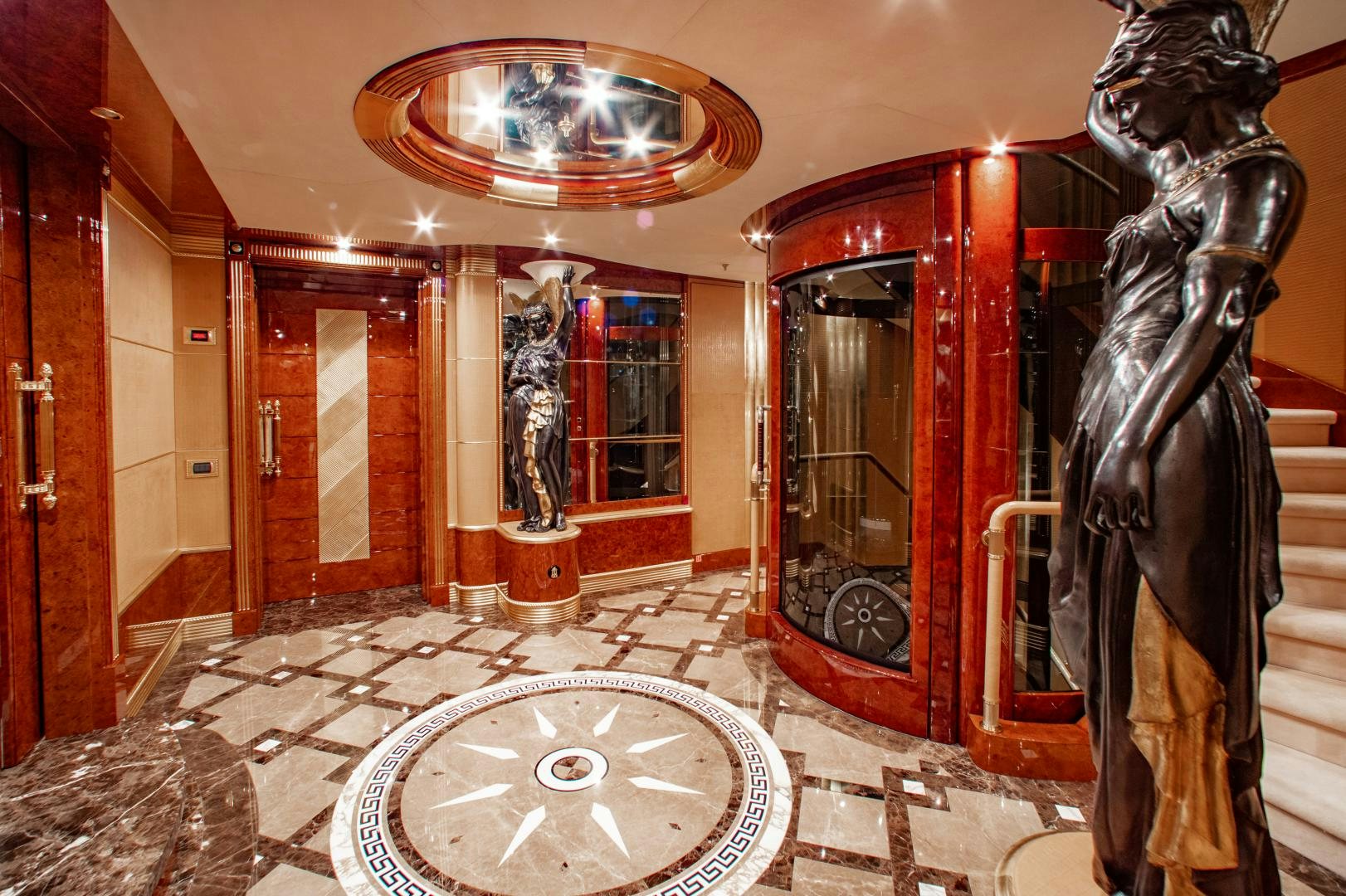a room with statues and a chandelier aboard SORRENTO Yacht for Sale