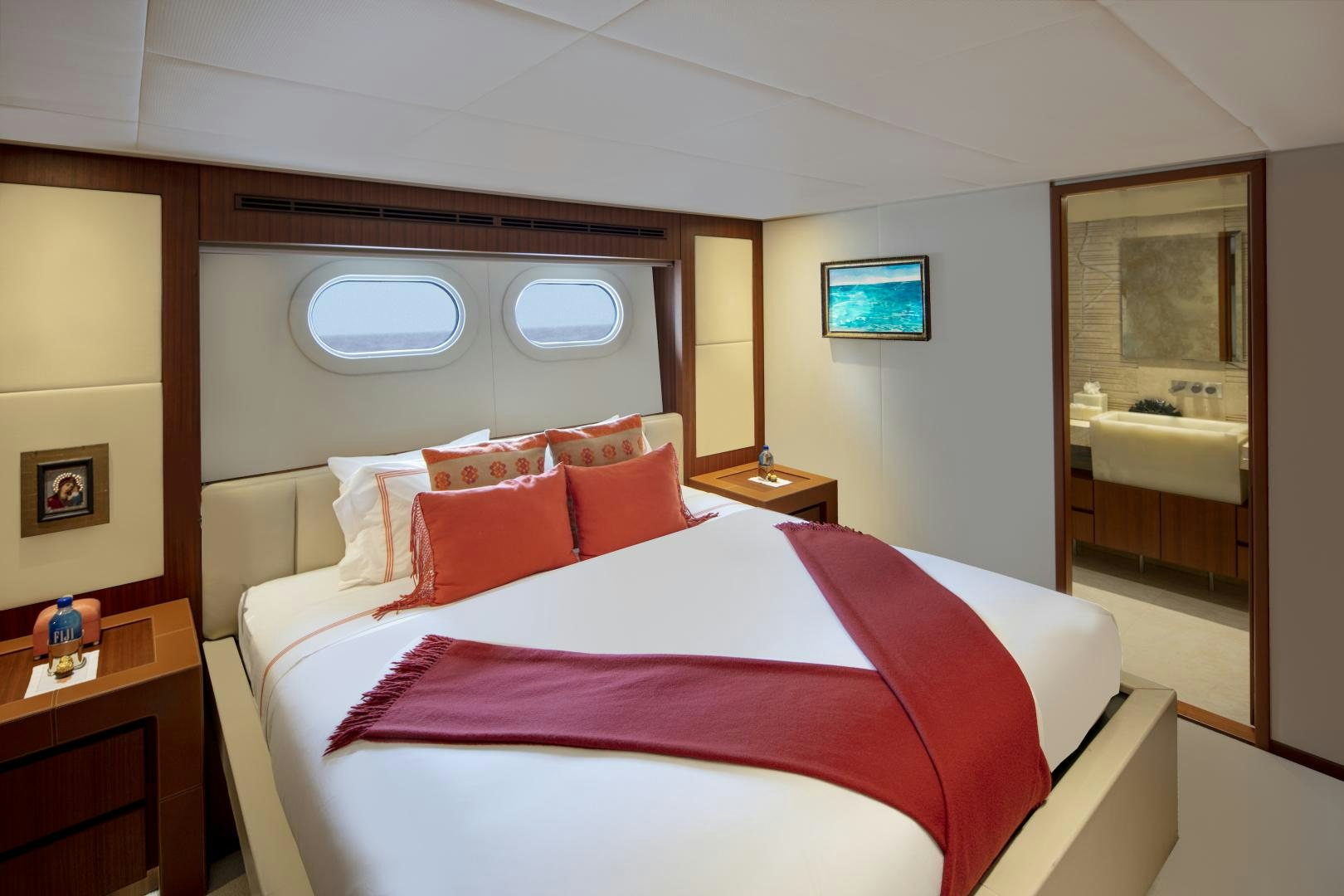 a bed with red pillows aboard CHAMPAGNE SEAS Yacht for Sale