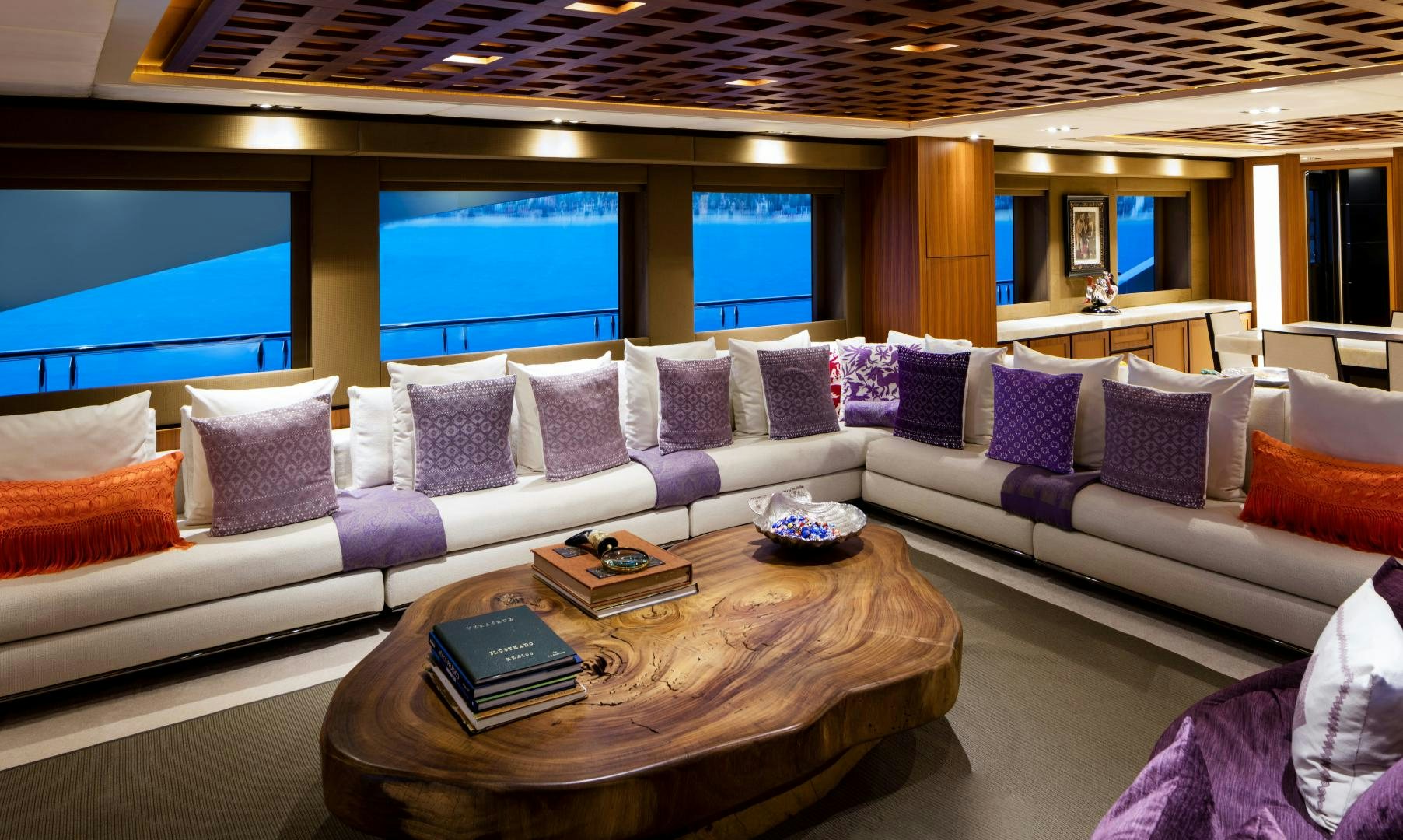 a large living room with a large sofa and a table aboard CHAMPAGNE SEAS Yacht for Sale