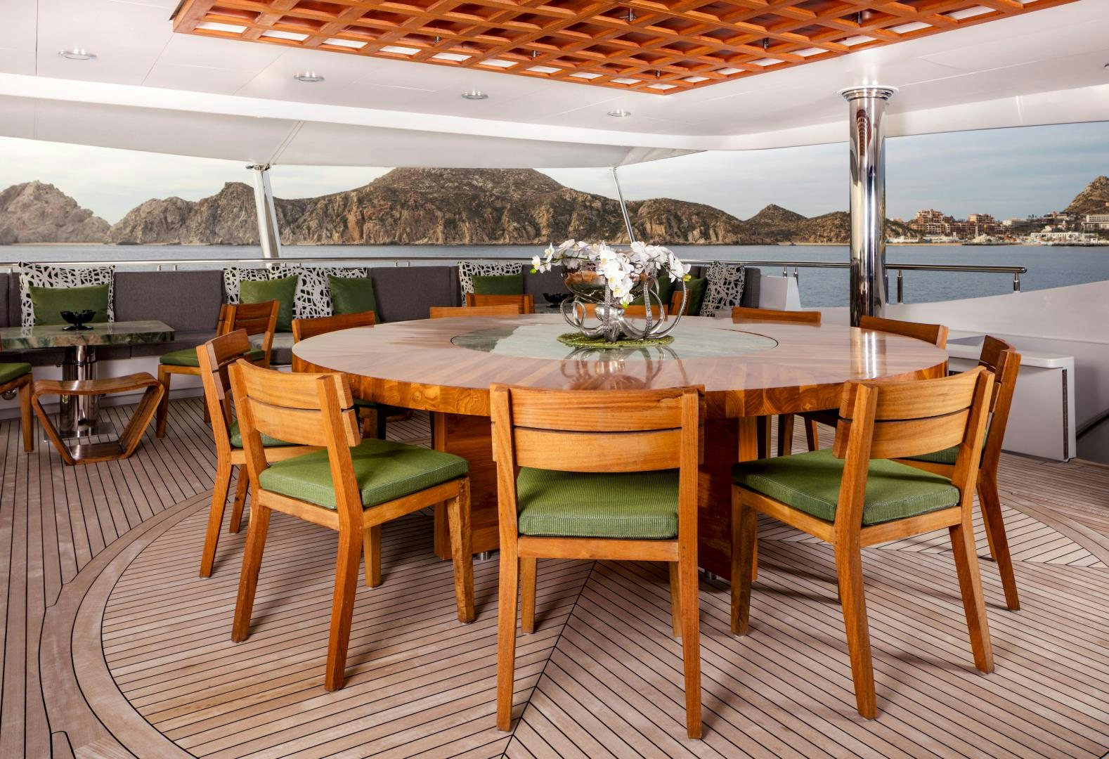 a table set with green chairs aboard CHAMPAGNE SEAS Yacht for Sale