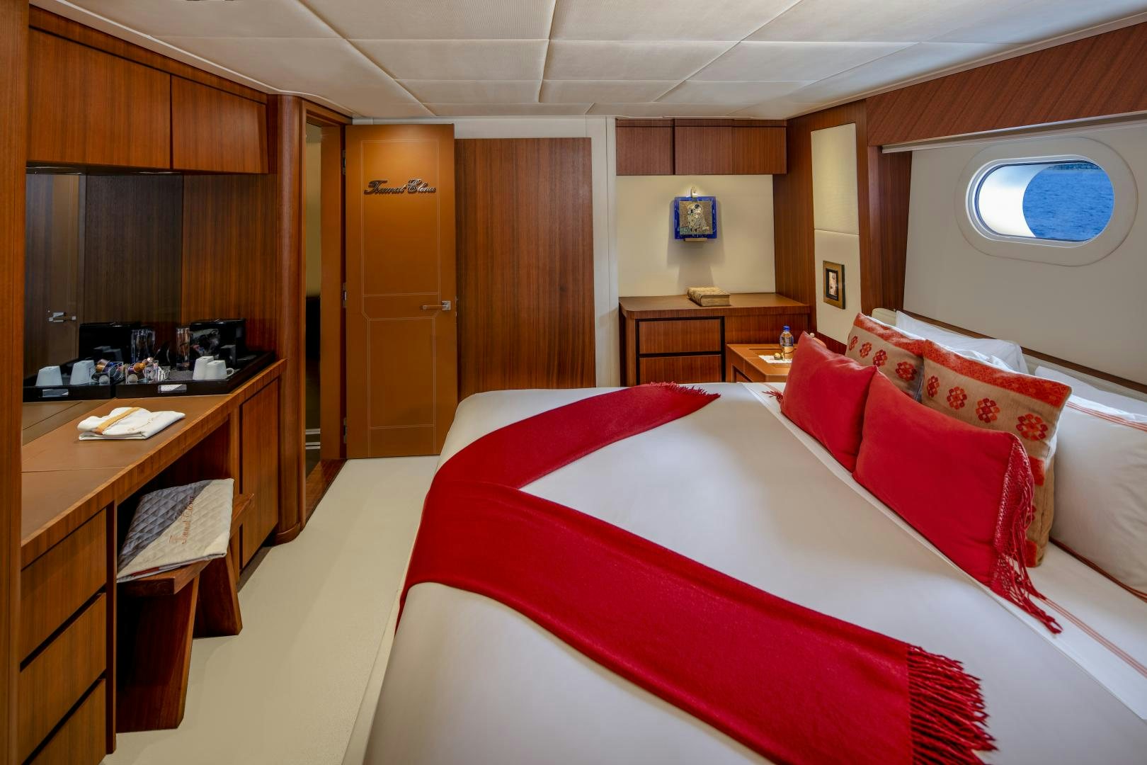 a room with a bed and desk aboard CHAMPAGNE SEAS Yacht for Sale