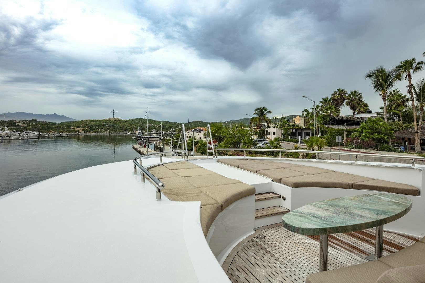 a pool with a deck and trees in the background aboard CHAMPAGNE SEAS Yacht for Sale