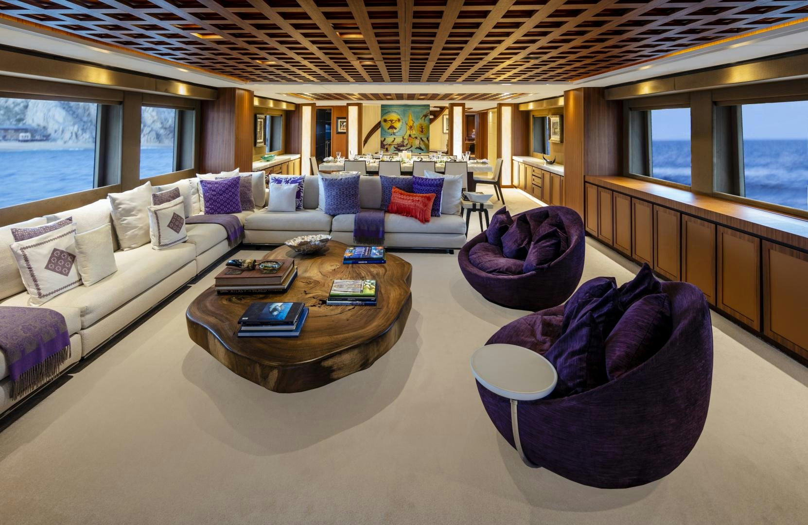 a living room with a large sectional sofa and a coffee table aboard CHAMPAGNE SEAS Yacht for Sale