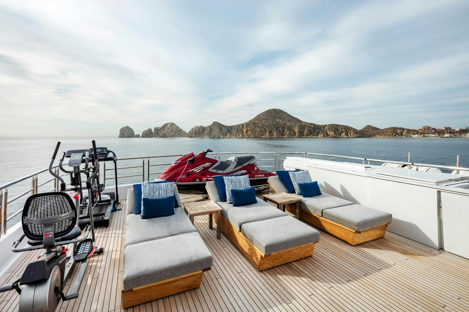 a deck with chairs and a boat on it aboard CHAMPAGNE SEAS Yacht for Sale