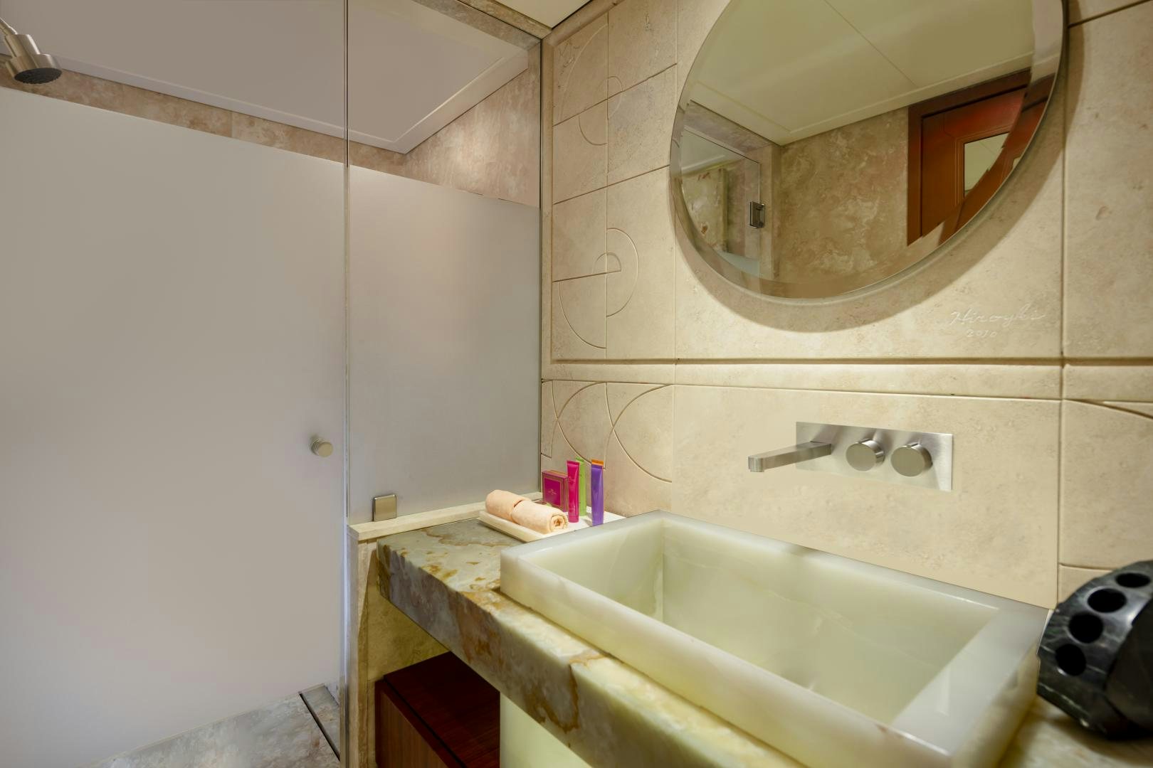 a bathroom with a large round mirror aboard CHAMPAGNE SEAS Yacht for Sale