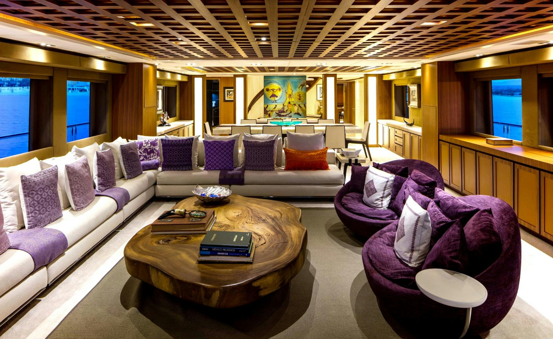 a large living room with a large blue couch and a large screen aboard CHAMPAGNE SEAS Yacht for Sale